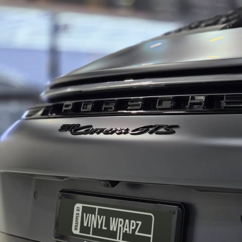 Porsche and Carrera GTS lettering across the satin grey rear panel
