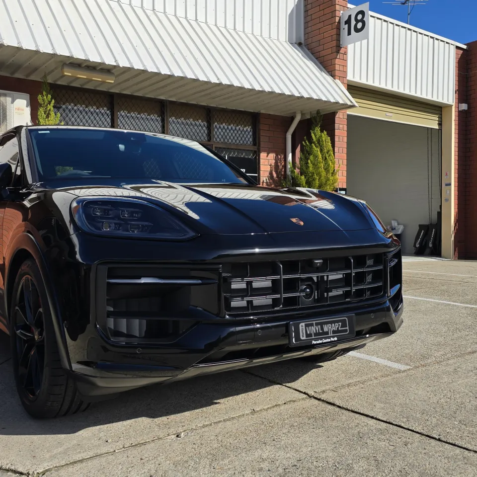 Gloss black Porsche Cayenne GTS parked outside the workshop