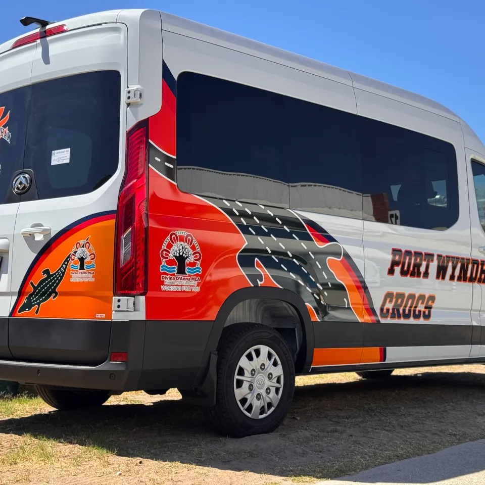 Rear-quarter view of the Port Wyndham Crocs van with crocodile artwork and orange graphics