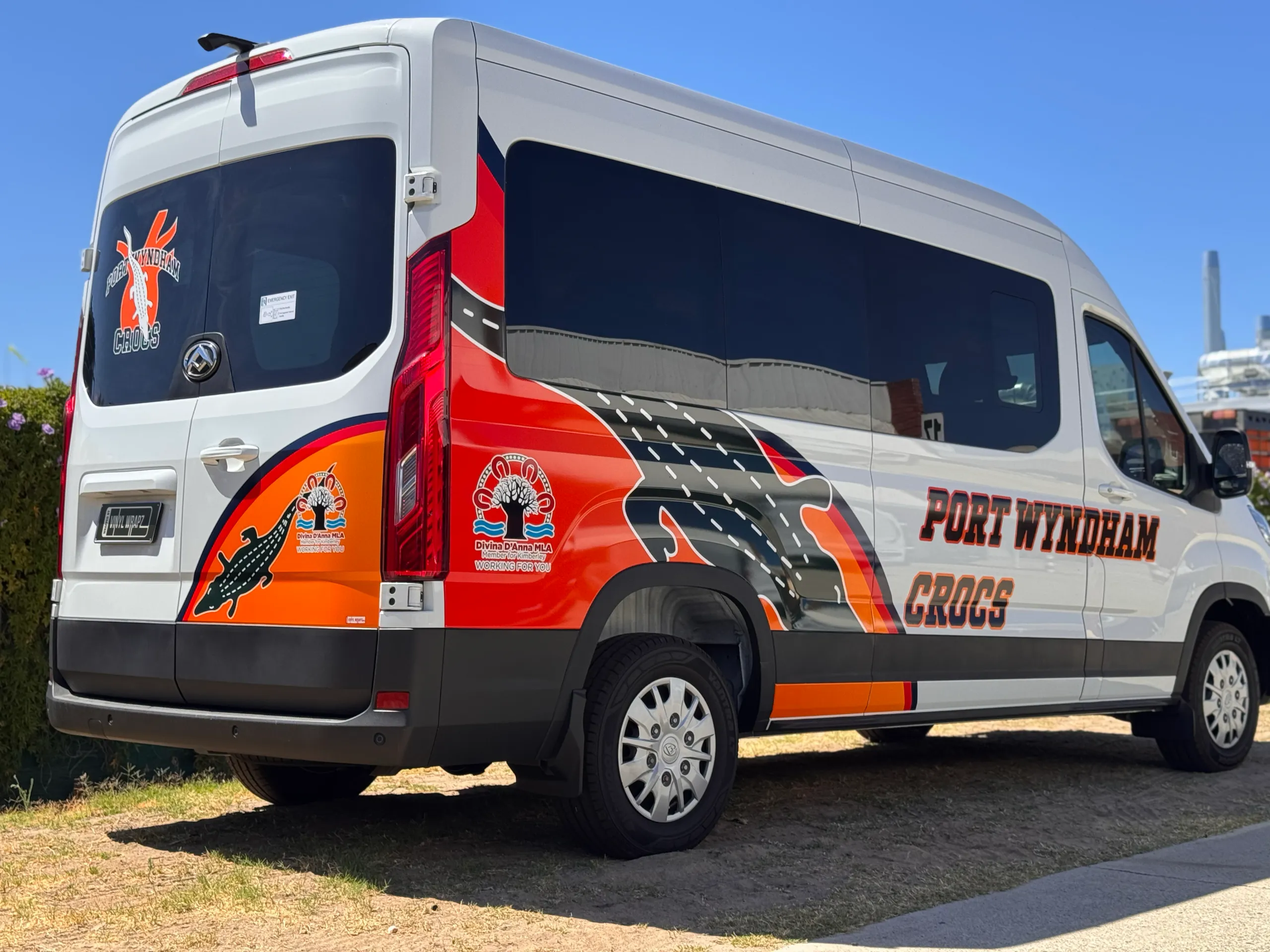 Rear-quarter view of the Port Wyndham Crocs van with crocodile artwork and orange graphics