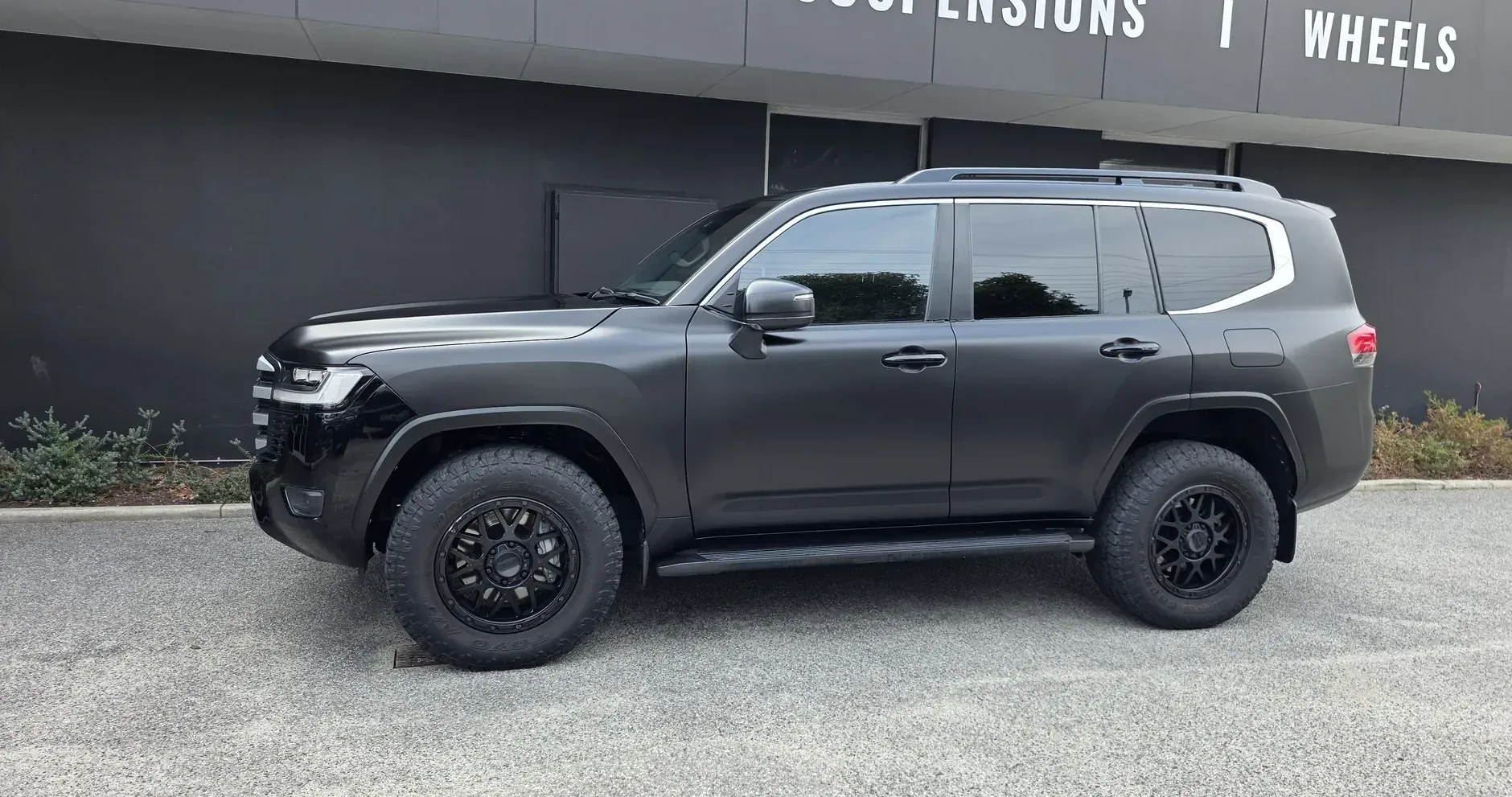 Toyota LandCruiser 300 in satin black paint protection film, side profile outside the Vinyl Wrapz workshop