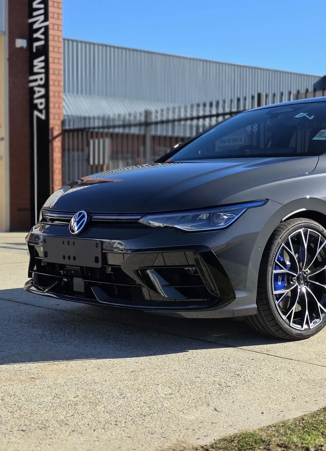 Grey Volkswagen Golf R in full gloss paint protection film outside the Vinyl Wrapz workshop