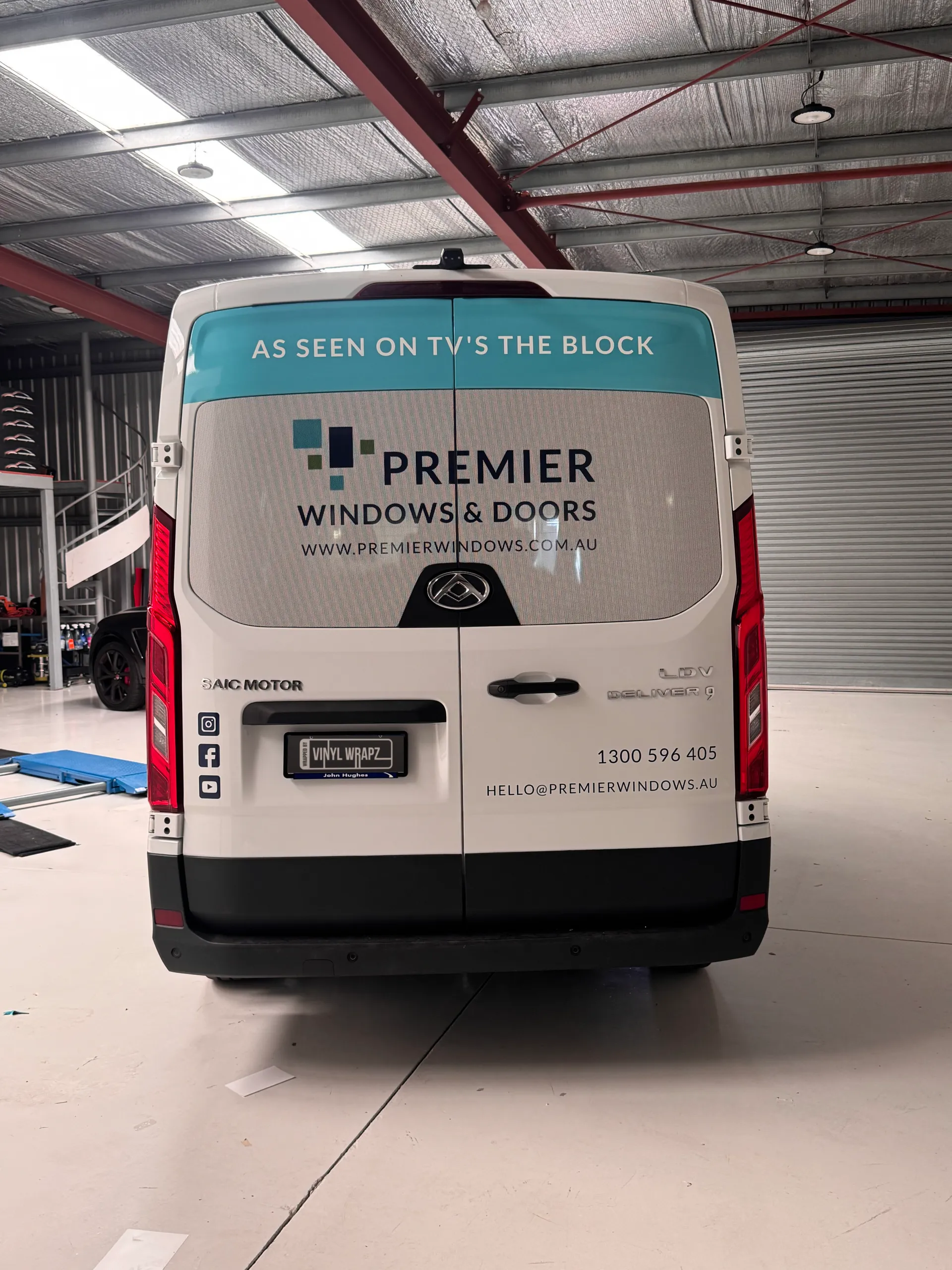 Rear view of the Premier Windows and Doors LDV van with turquoise and white branding