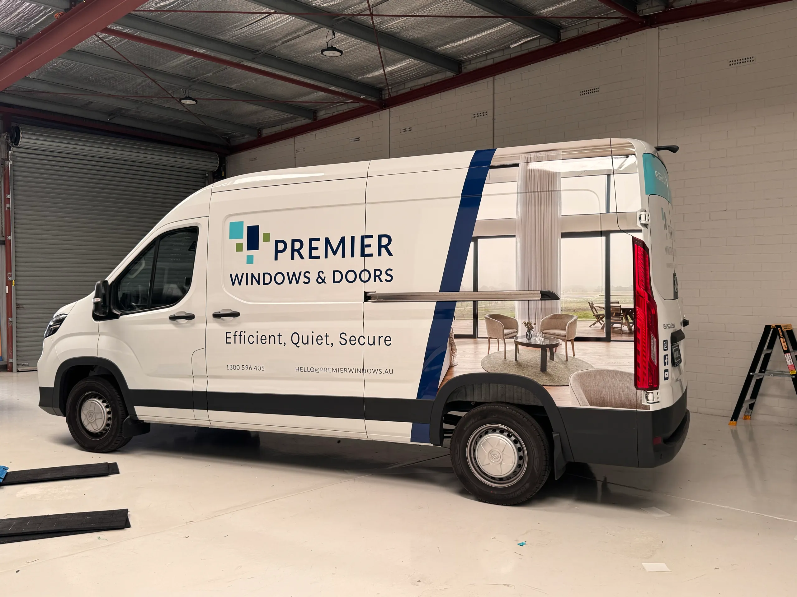 Premier Windows and Doors van with blue accents and a printed interior image along its side