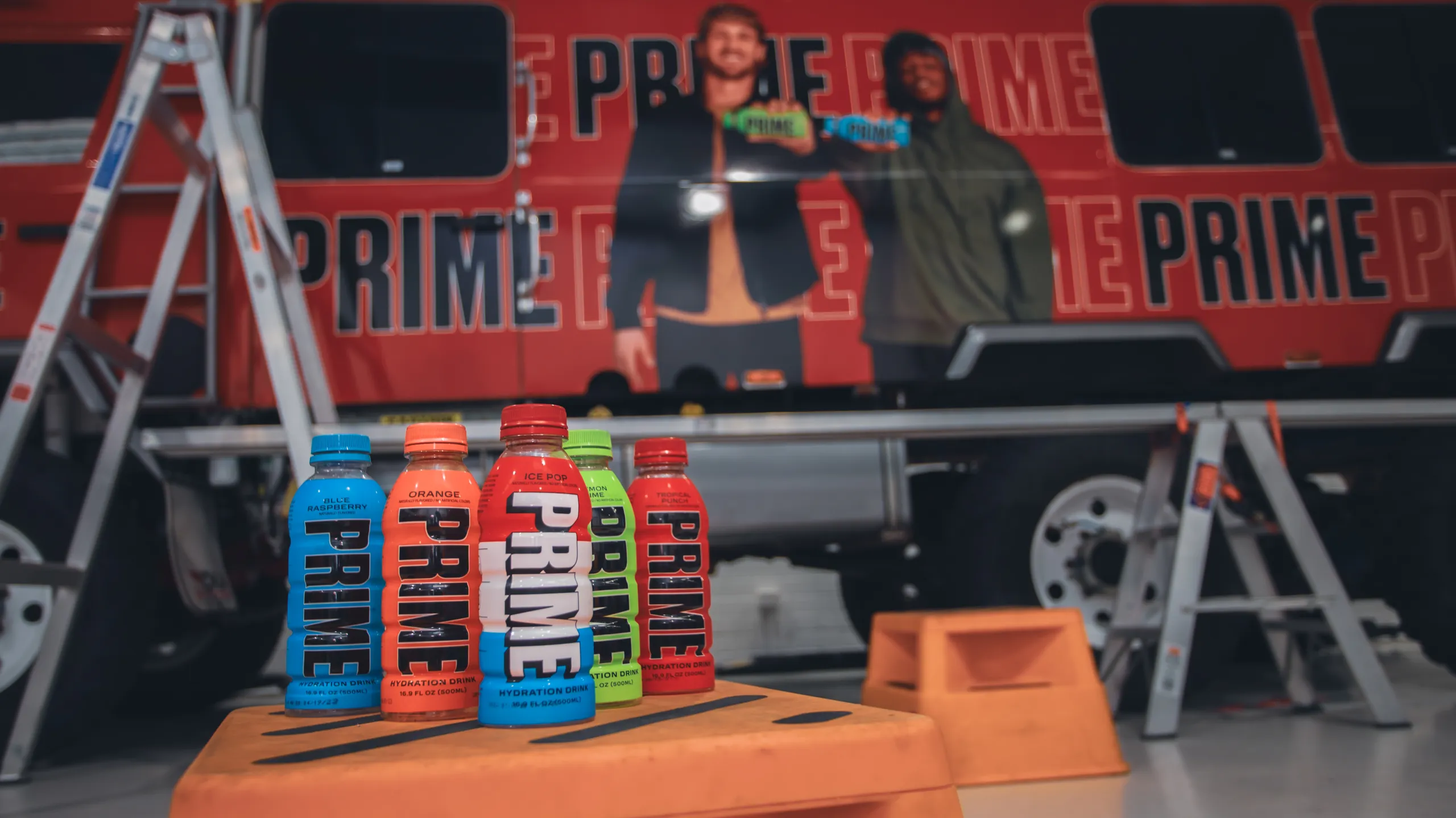 Prime Hydration bottles in front of the printed vehicle artwork