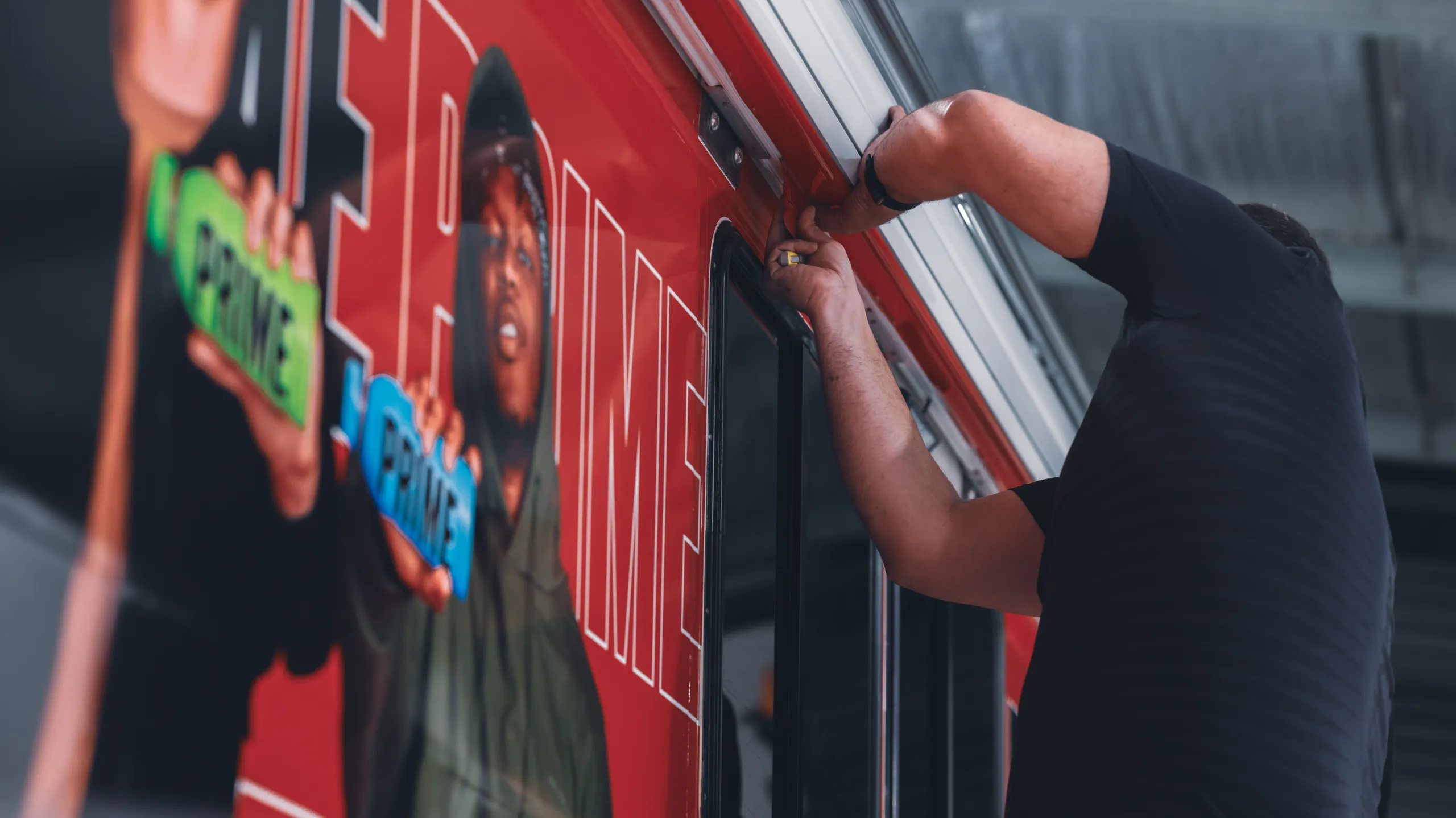 Installer pressing down a printed graphic on the Oka side