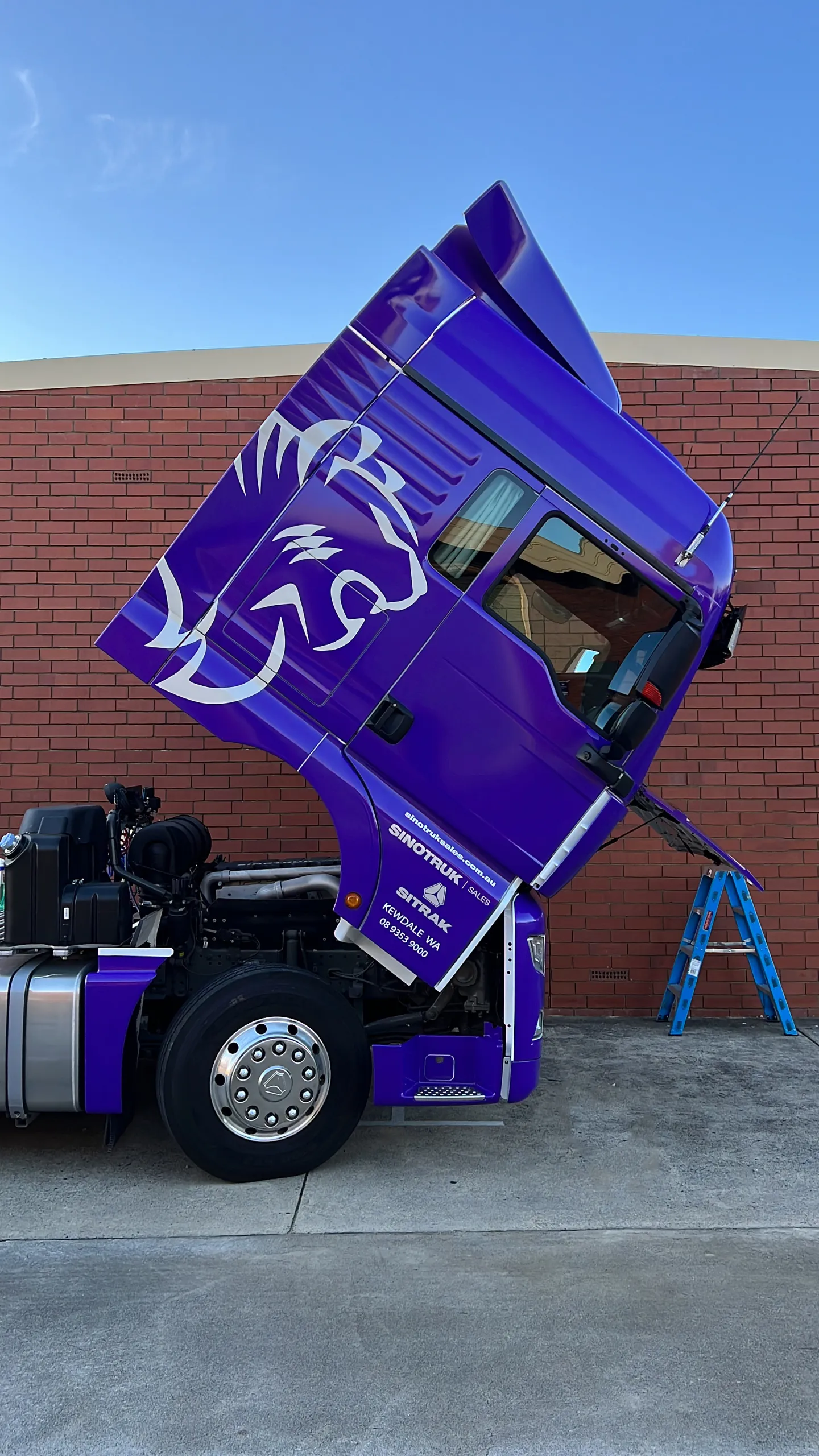 Purple cab tilted forward, showing the Instruckta branding