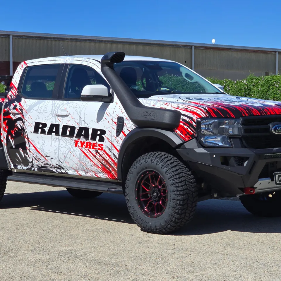 Ford Ranger with Radar Tyres graphics, a black bullbar and snorkel outside the workshop