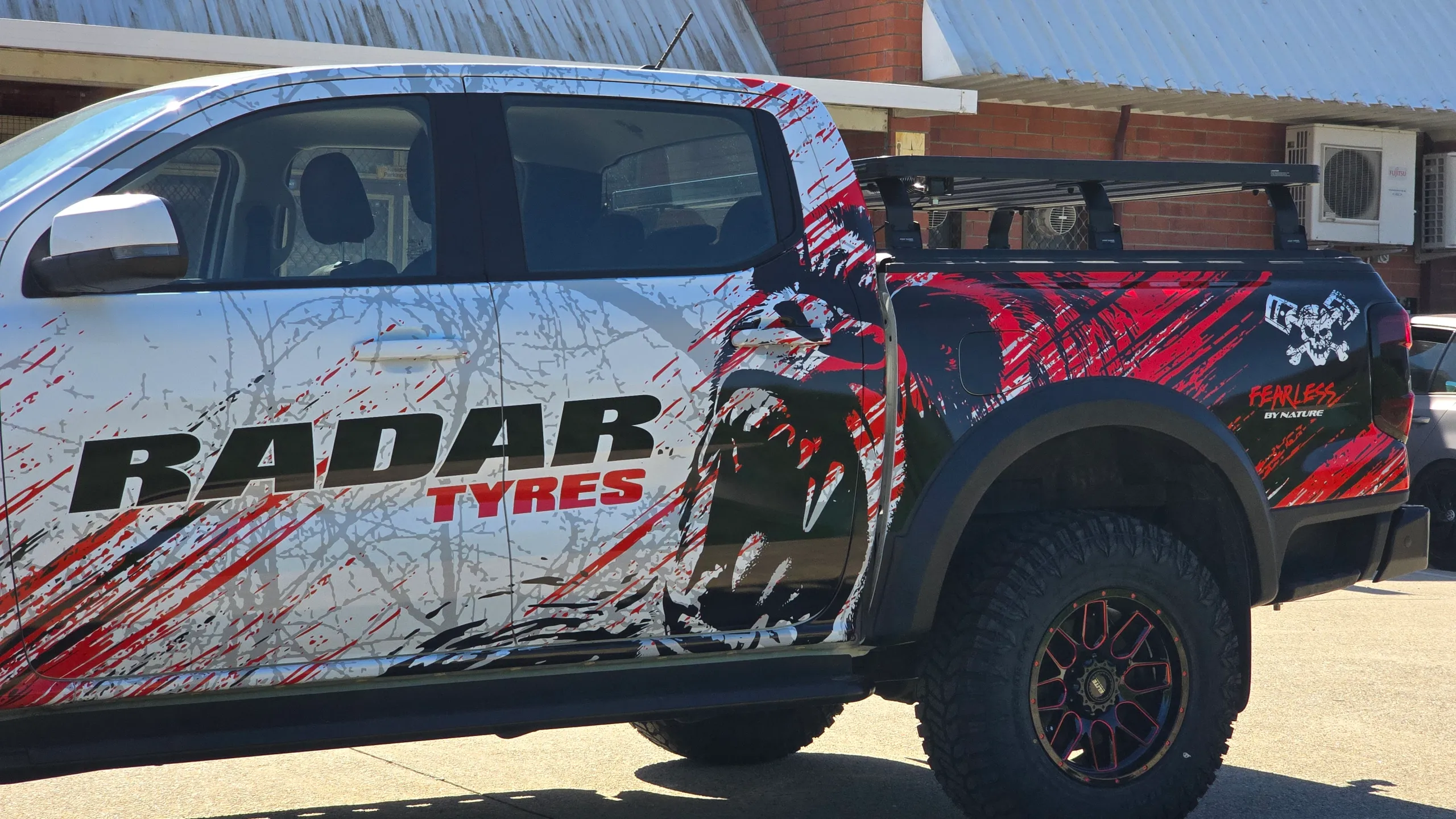 Radar Tyres lettering across the Ranger doors beside red and black tub graphics