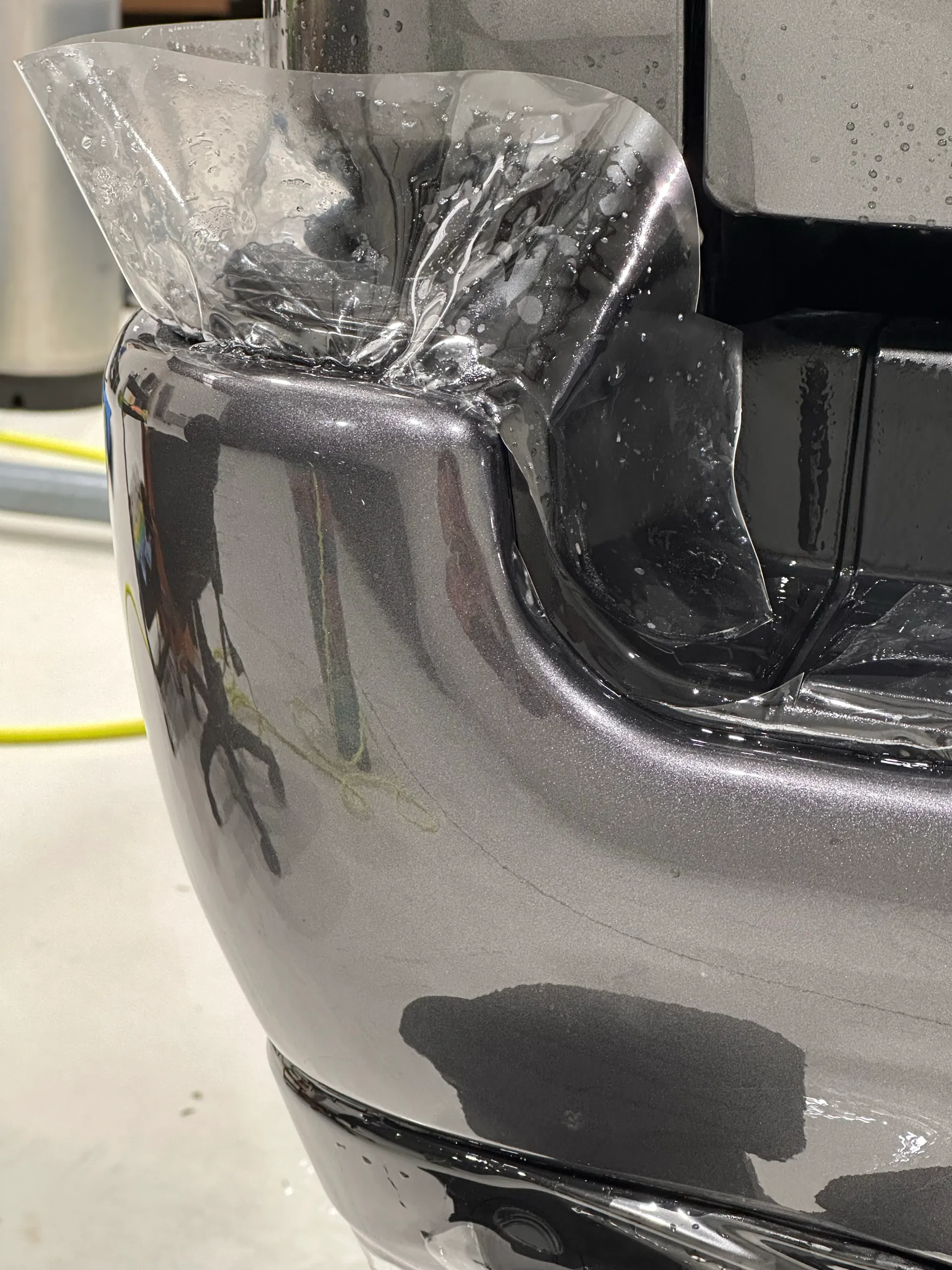 Clear film being fitted around the grey Ram rear bumper corner
