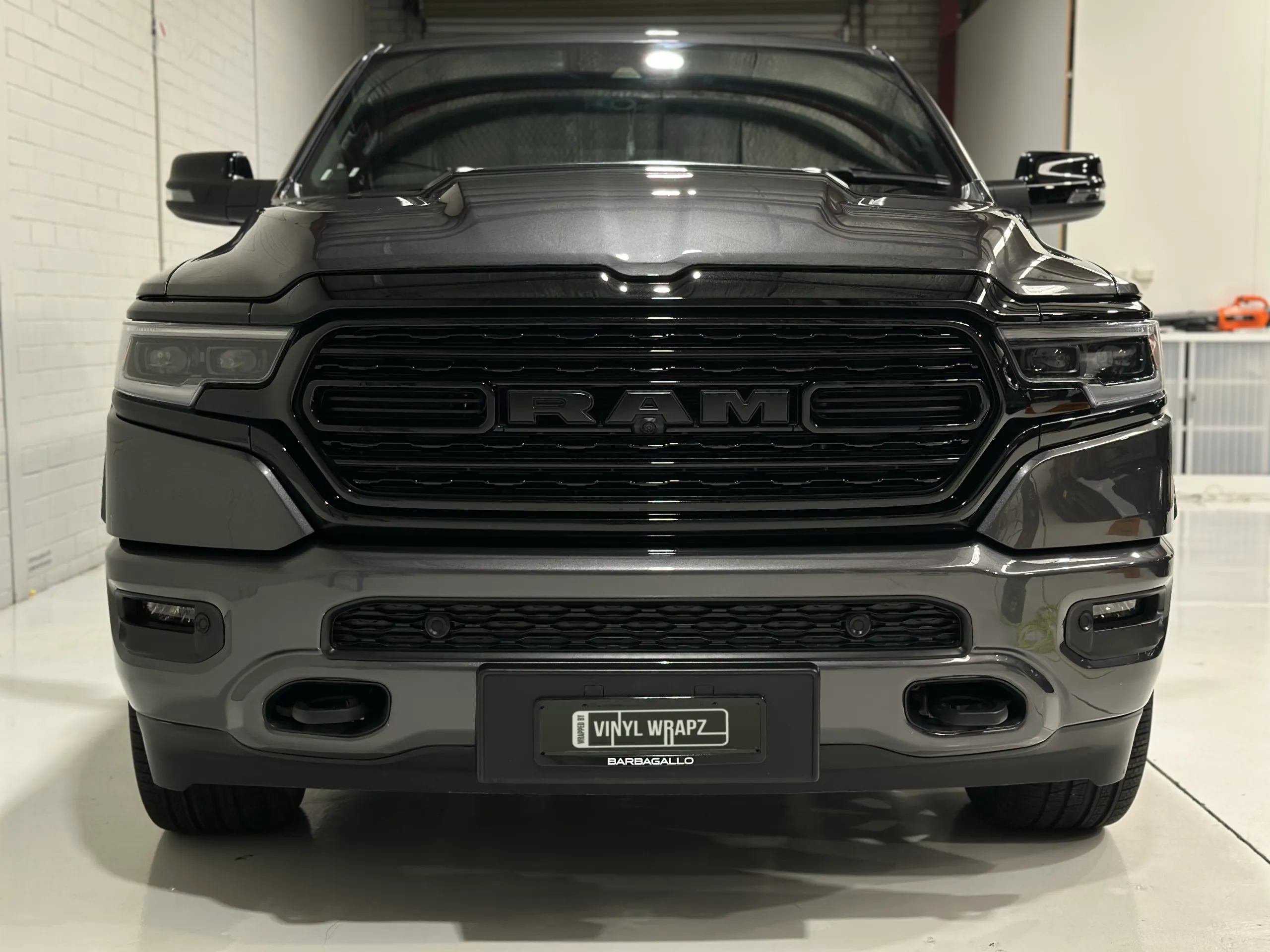 Head-on view of the metallic grey Ram 1500 in the workshop