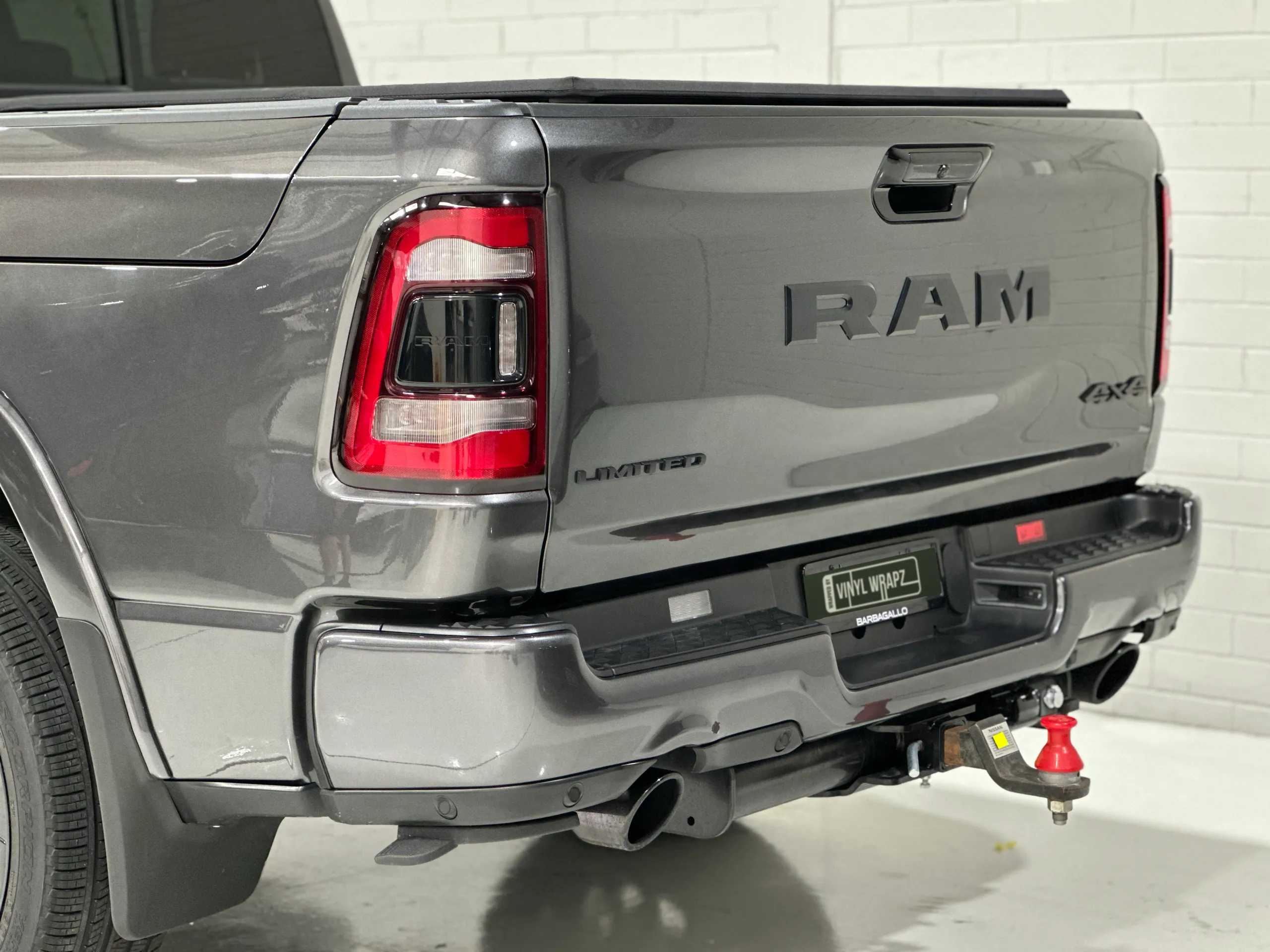 Grey Ram 1500 tailgate, rear light and tow bar viewed from the rear quarter