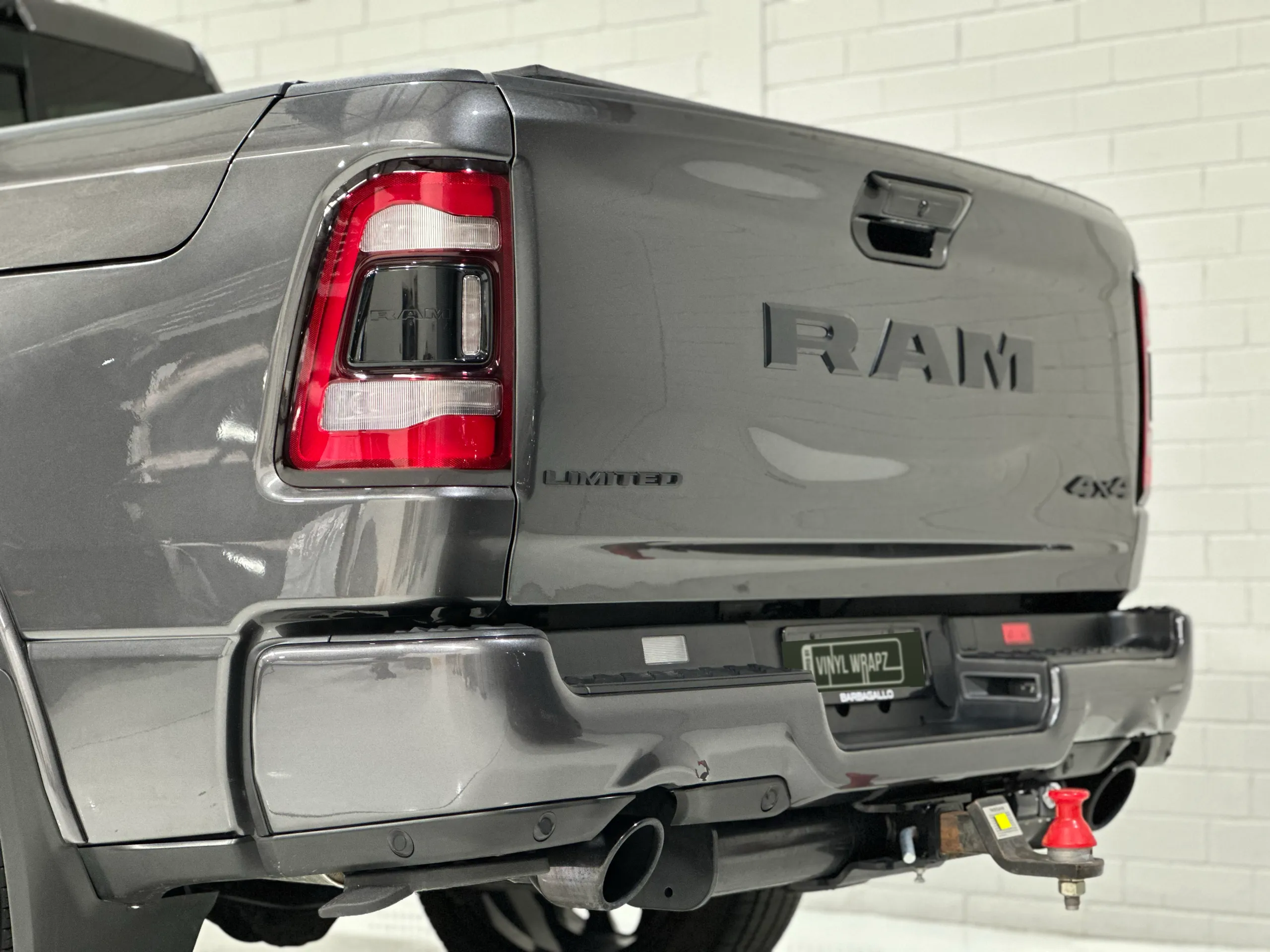 Close view of the grey Ram tailgate, rear bumper and red tow-ball cover