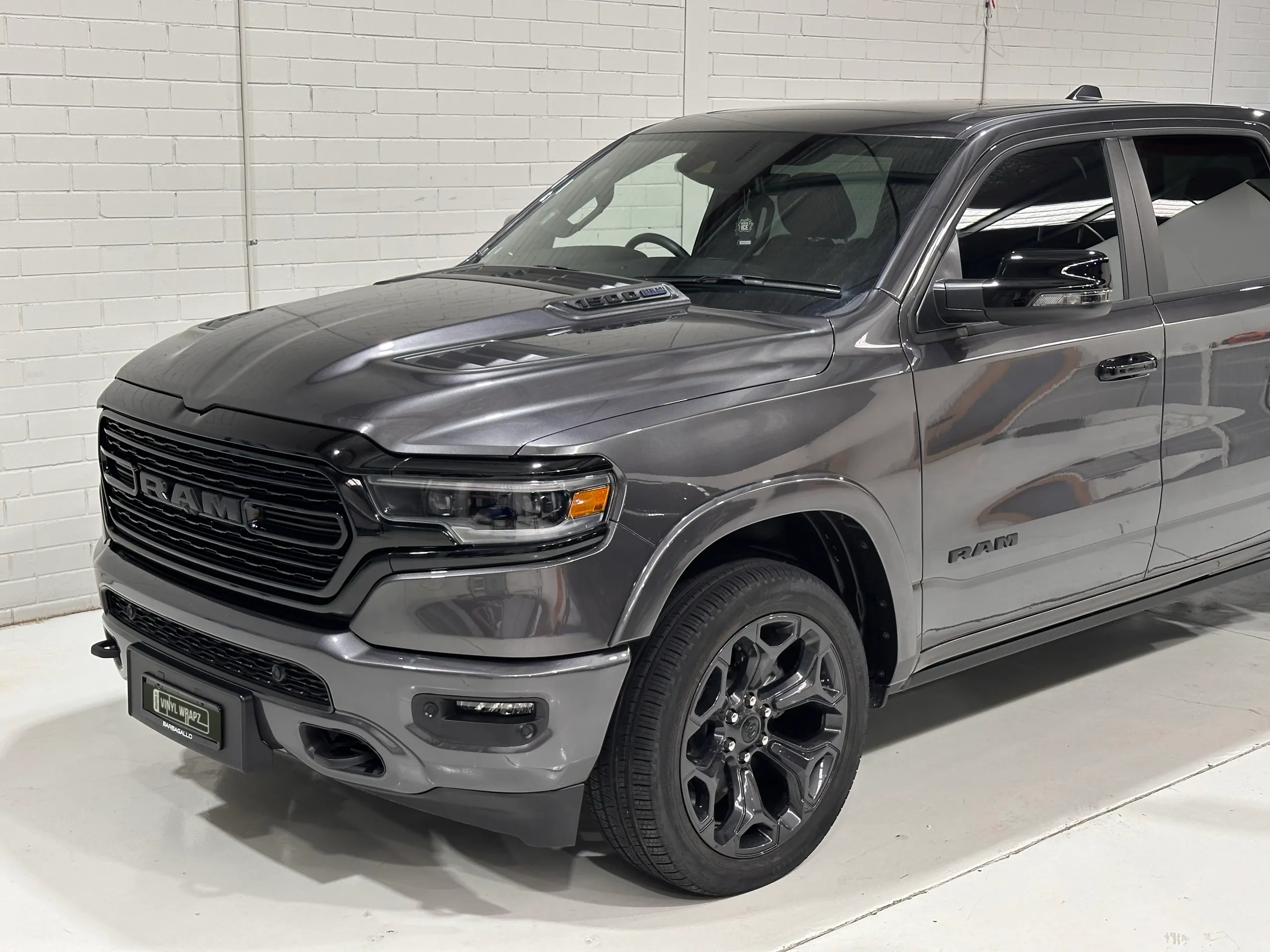 Elevated view of the grey Ram 1500 bonnet, front wheel and cab