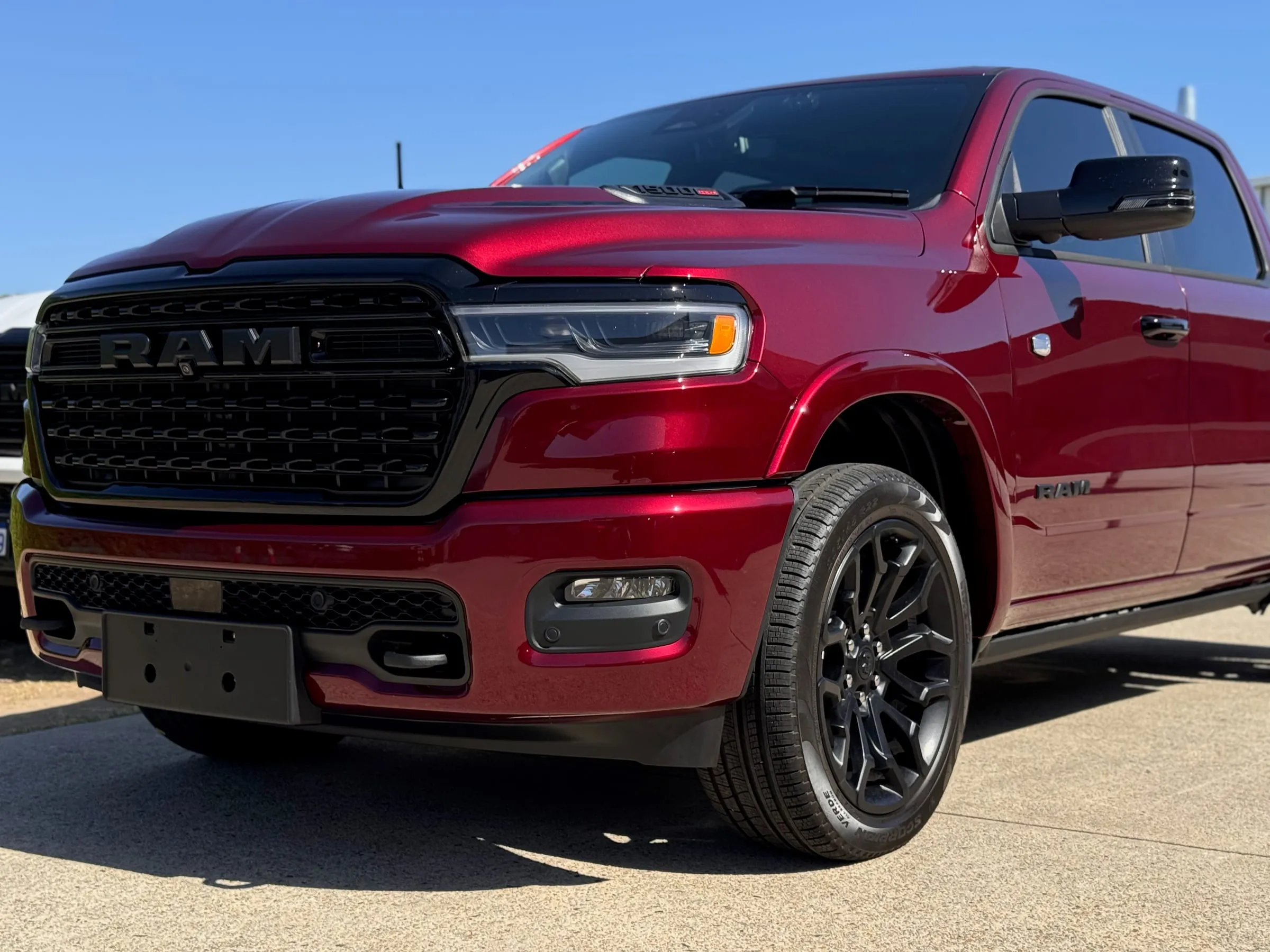 Red RAM 1500 with clear paint protection film on the bonnet, grille surround and front fender, outside the Vinyl Wrapz workshop