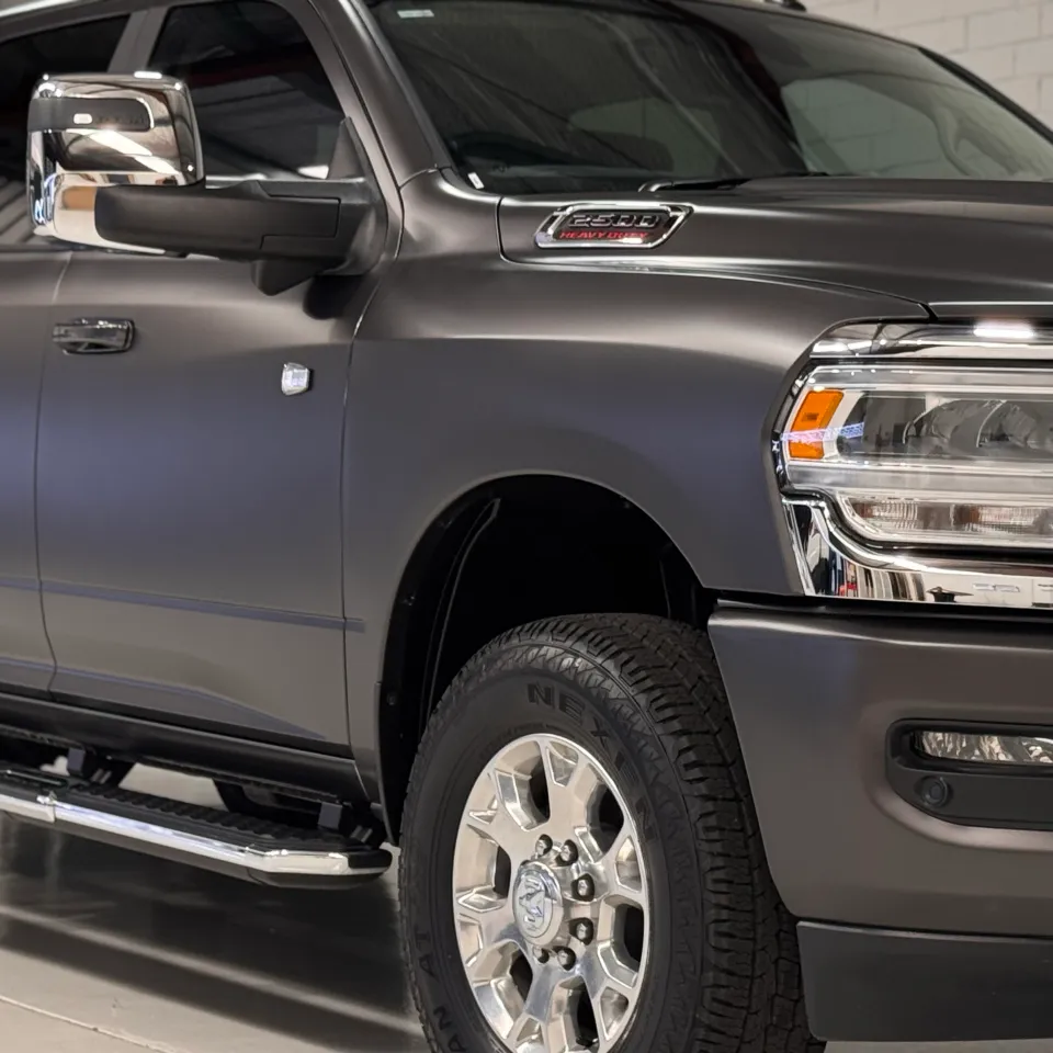Close view of the matte grey Ram 2500 front guard, headlight and cab