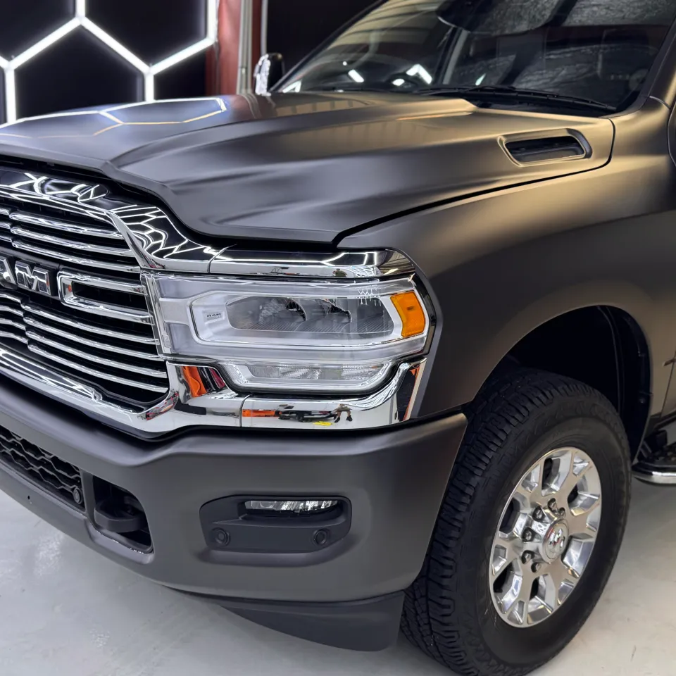 Satin dark grey Ram 2500 front quarter with a chrome grille and front wheel