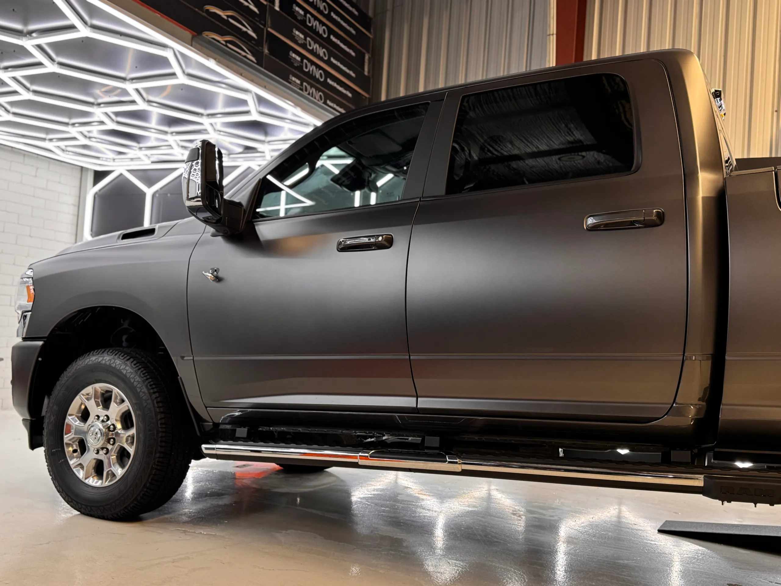 Side detail of the satin grey Ram cab, front wheel and side step
