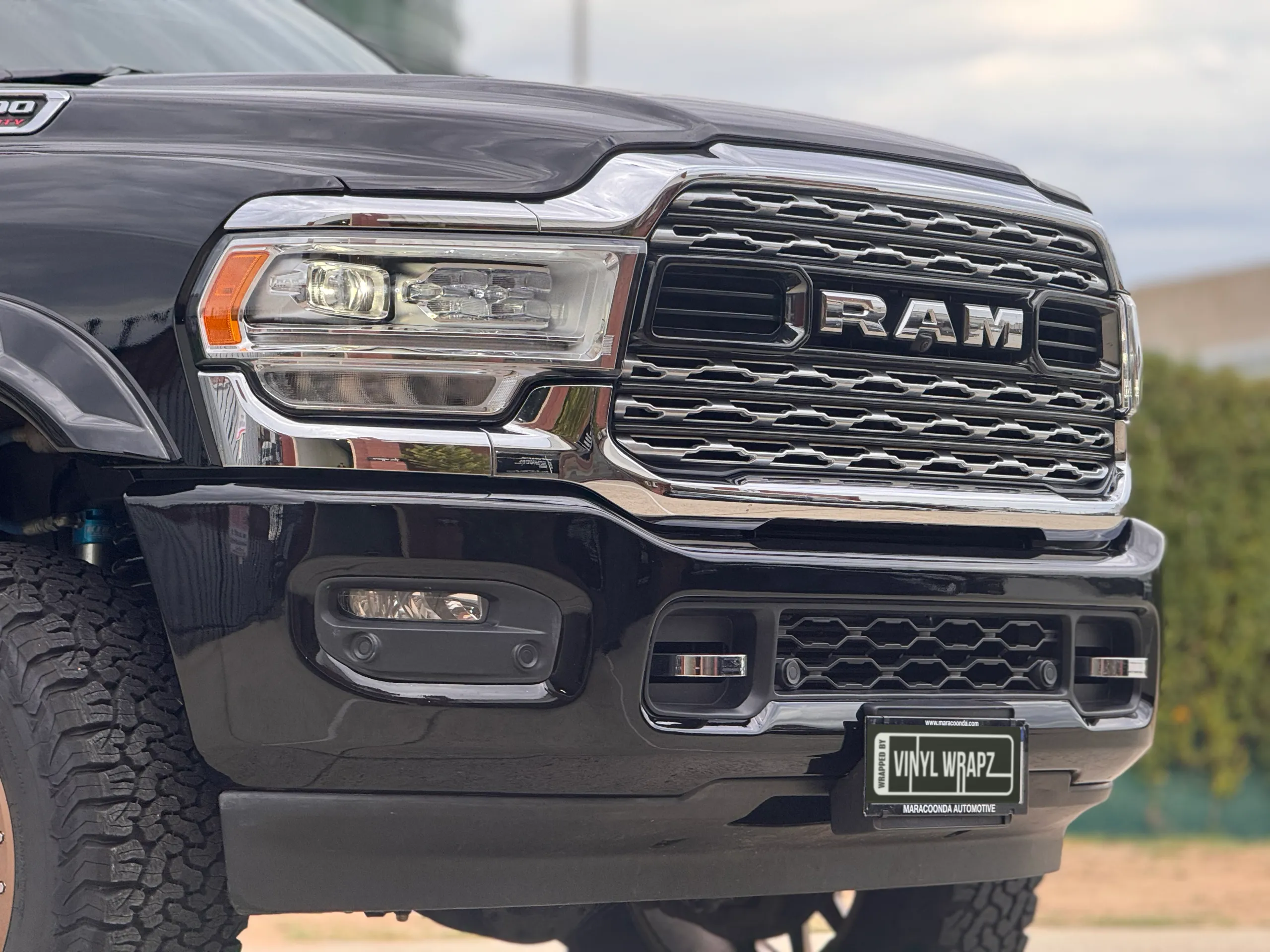 Chrome grille, Ram badge and headlight on the black Ram 3500