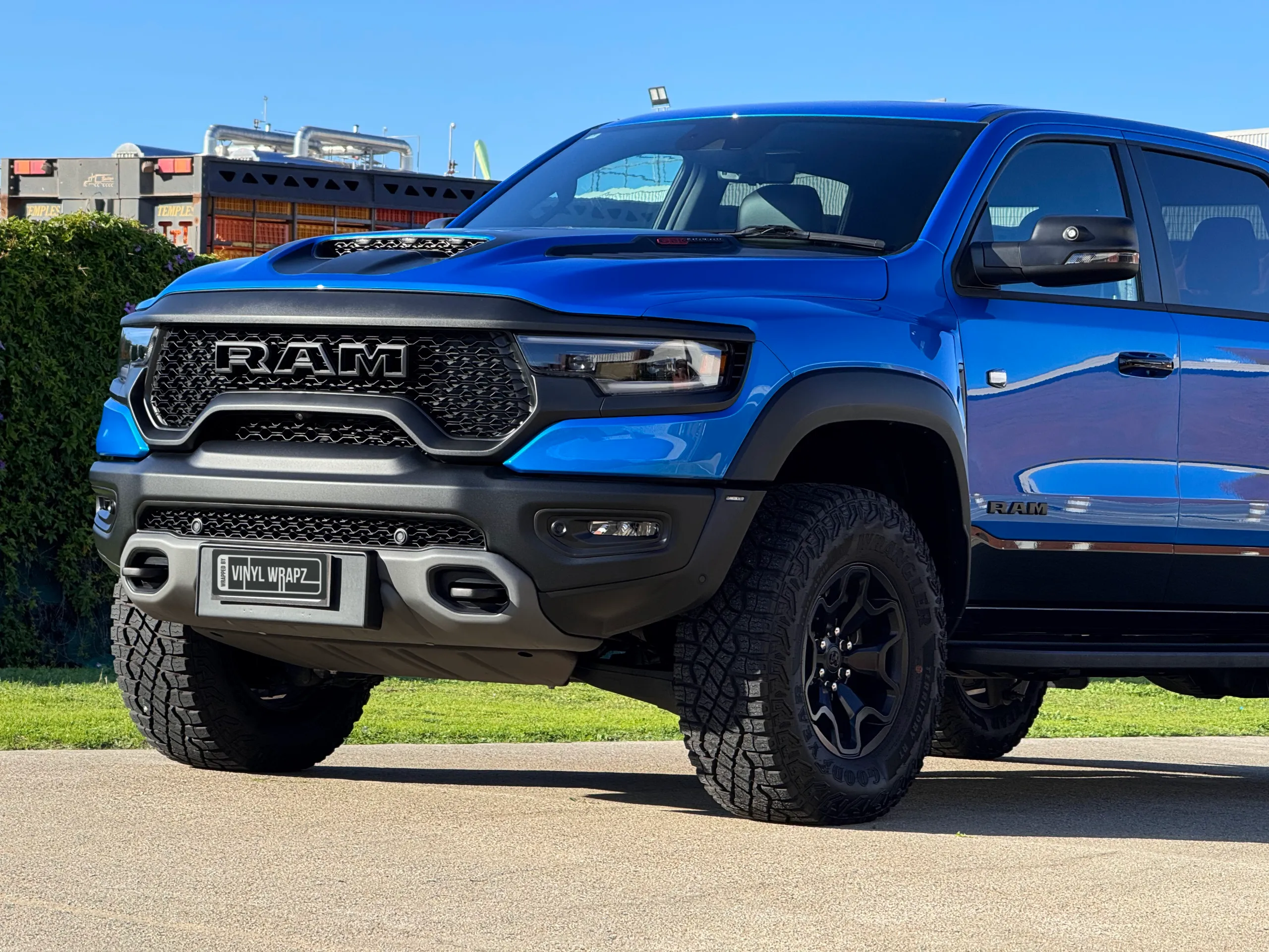Gloss blue Ram TRX front end, bonnet scoop and front wheel outdoors