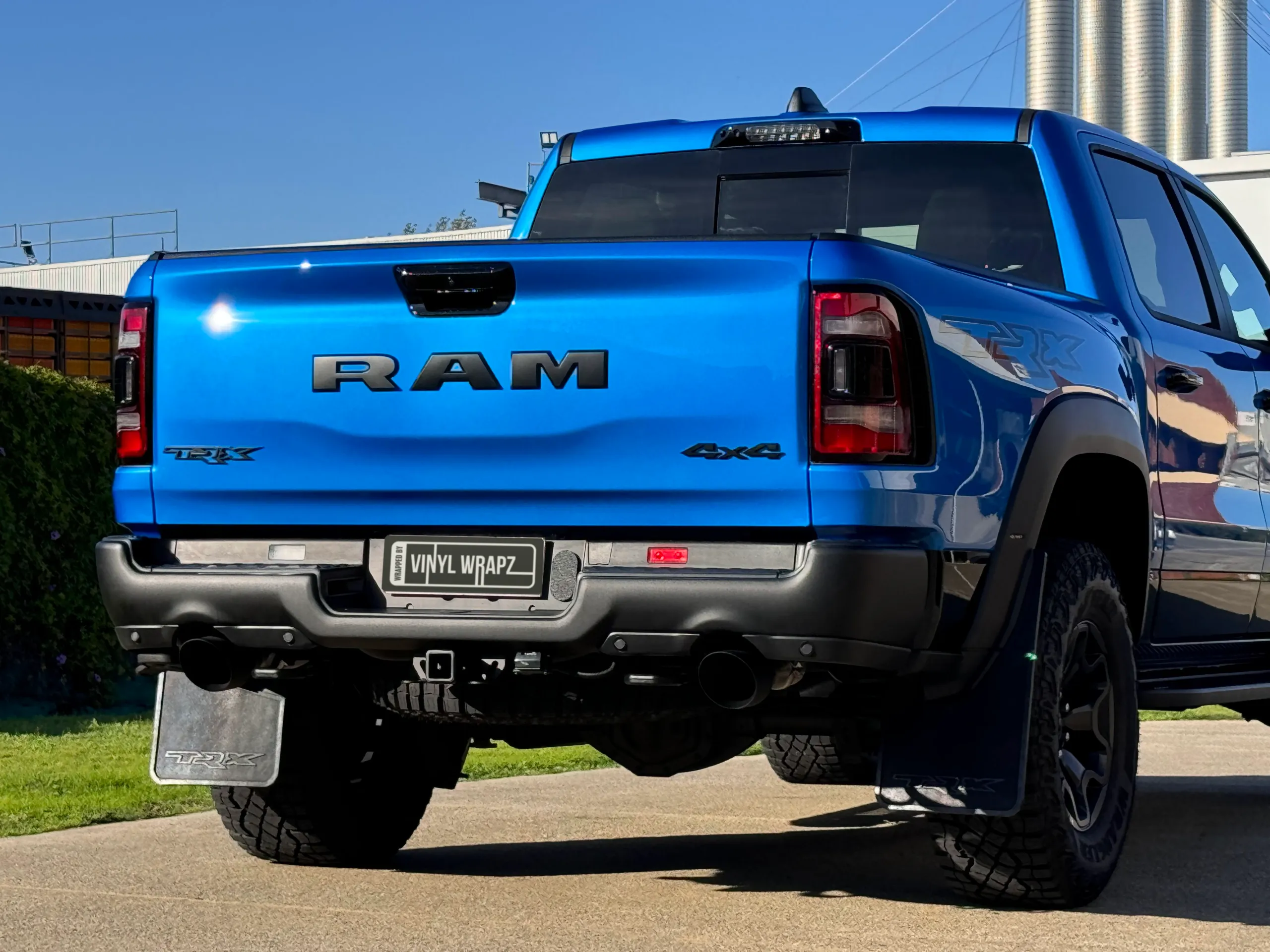Blue Ram TRX tailgate, rear bumper and rear wheel in sunlight