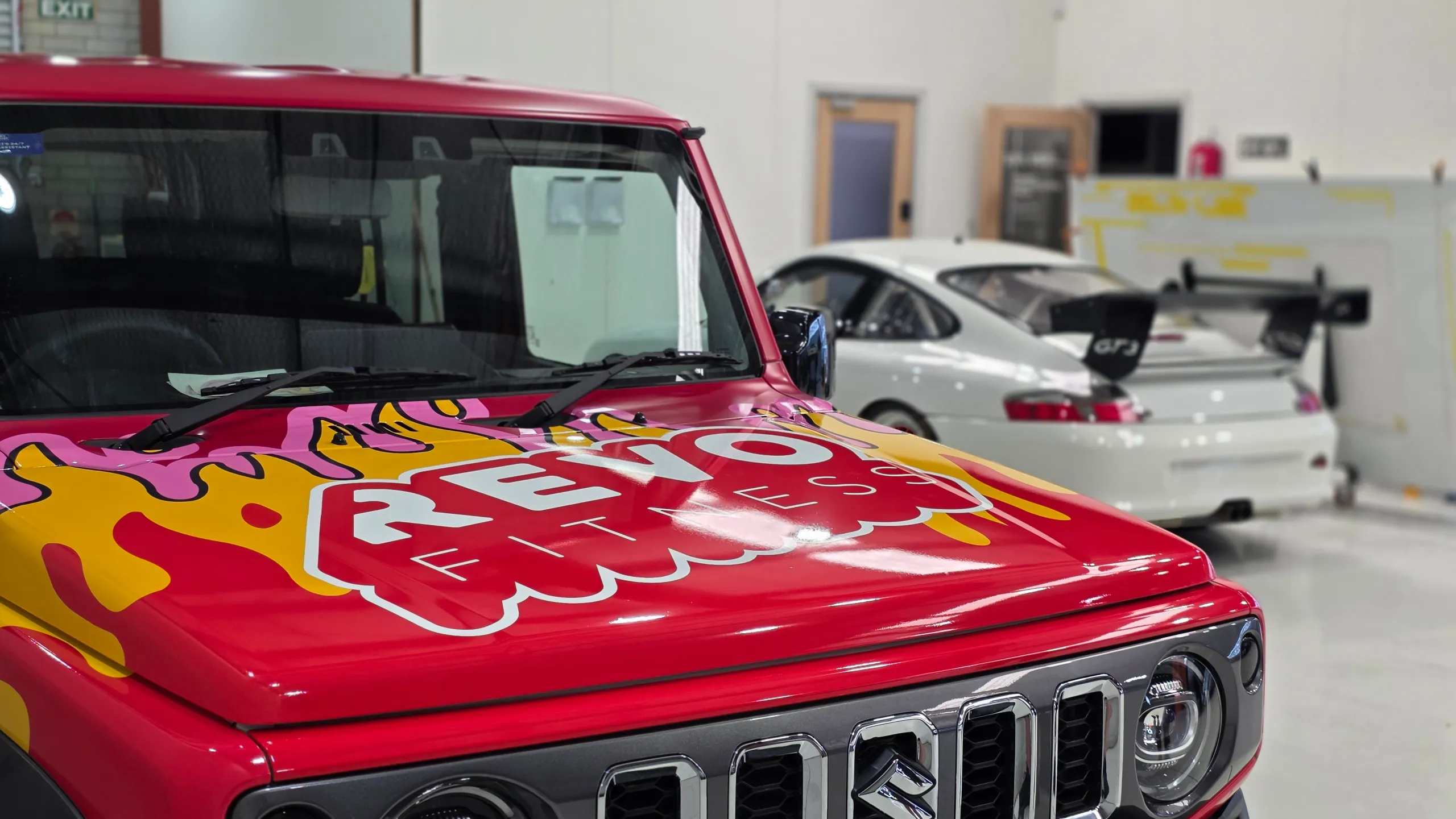 Revo Fitness bonnet graphics on the red Suzuki Jimny above its grille