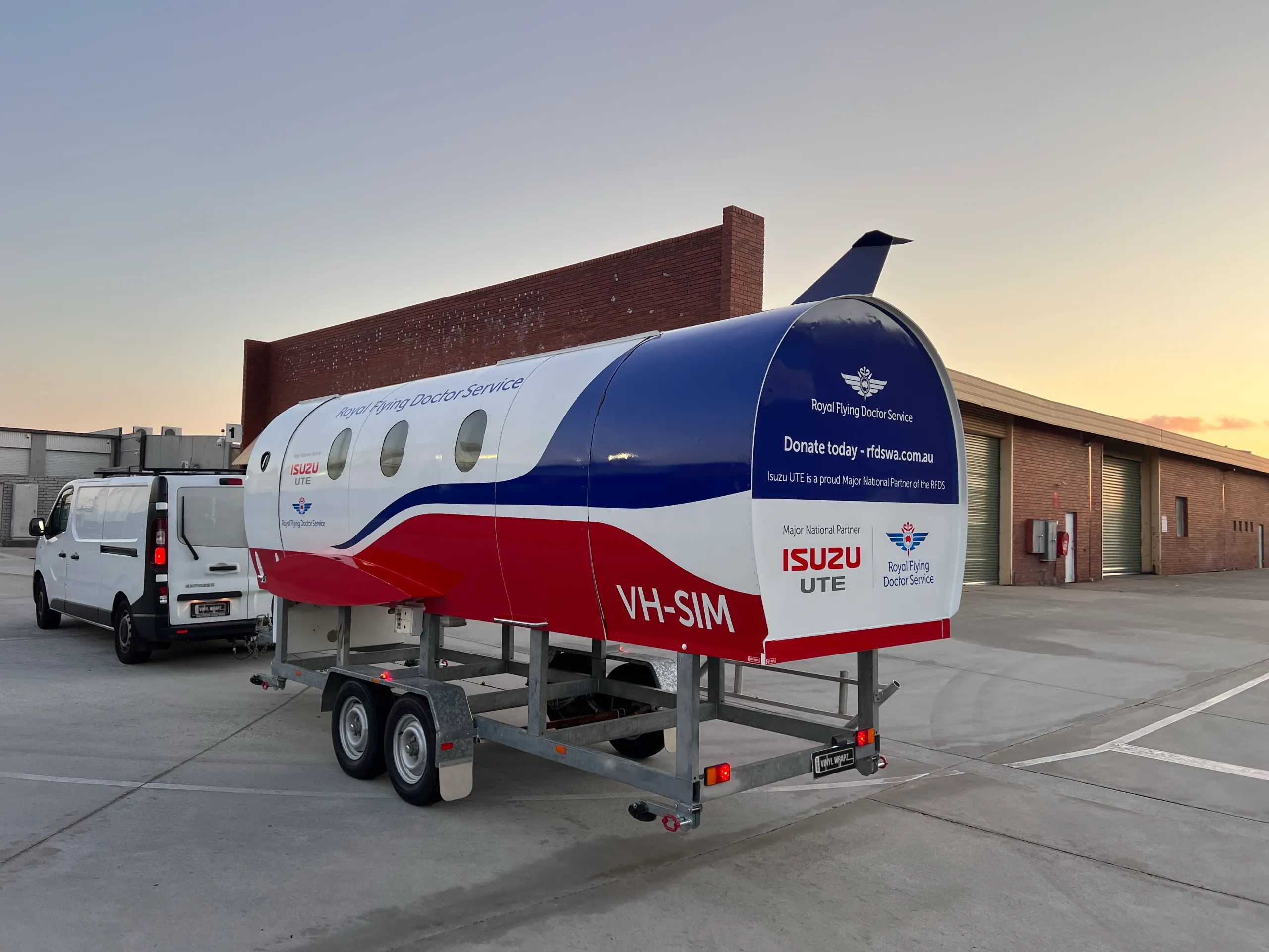Rear-quarter view of the branded training pod and tow vehicle