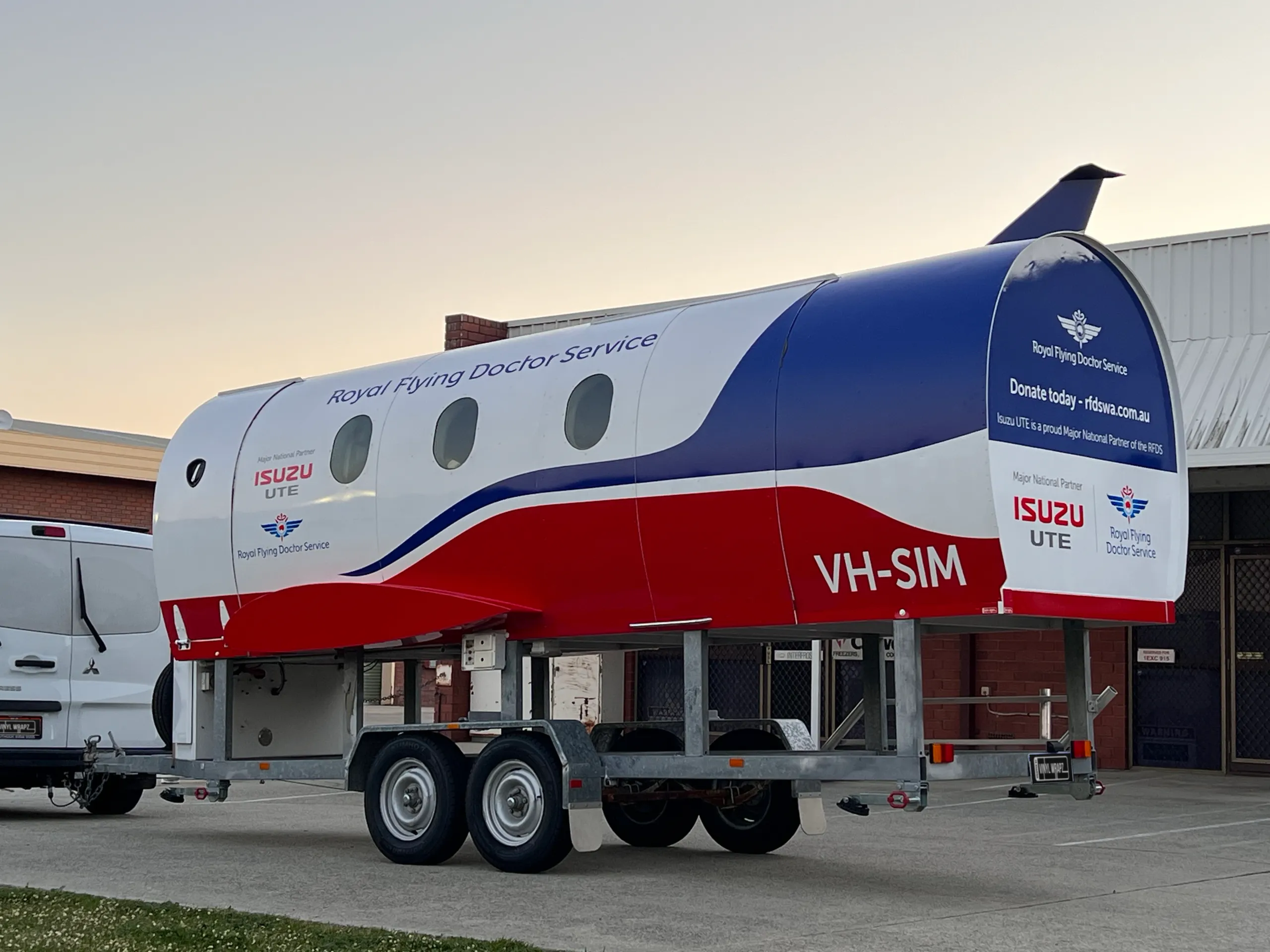 Front and side view of the branded training pod near its towbar