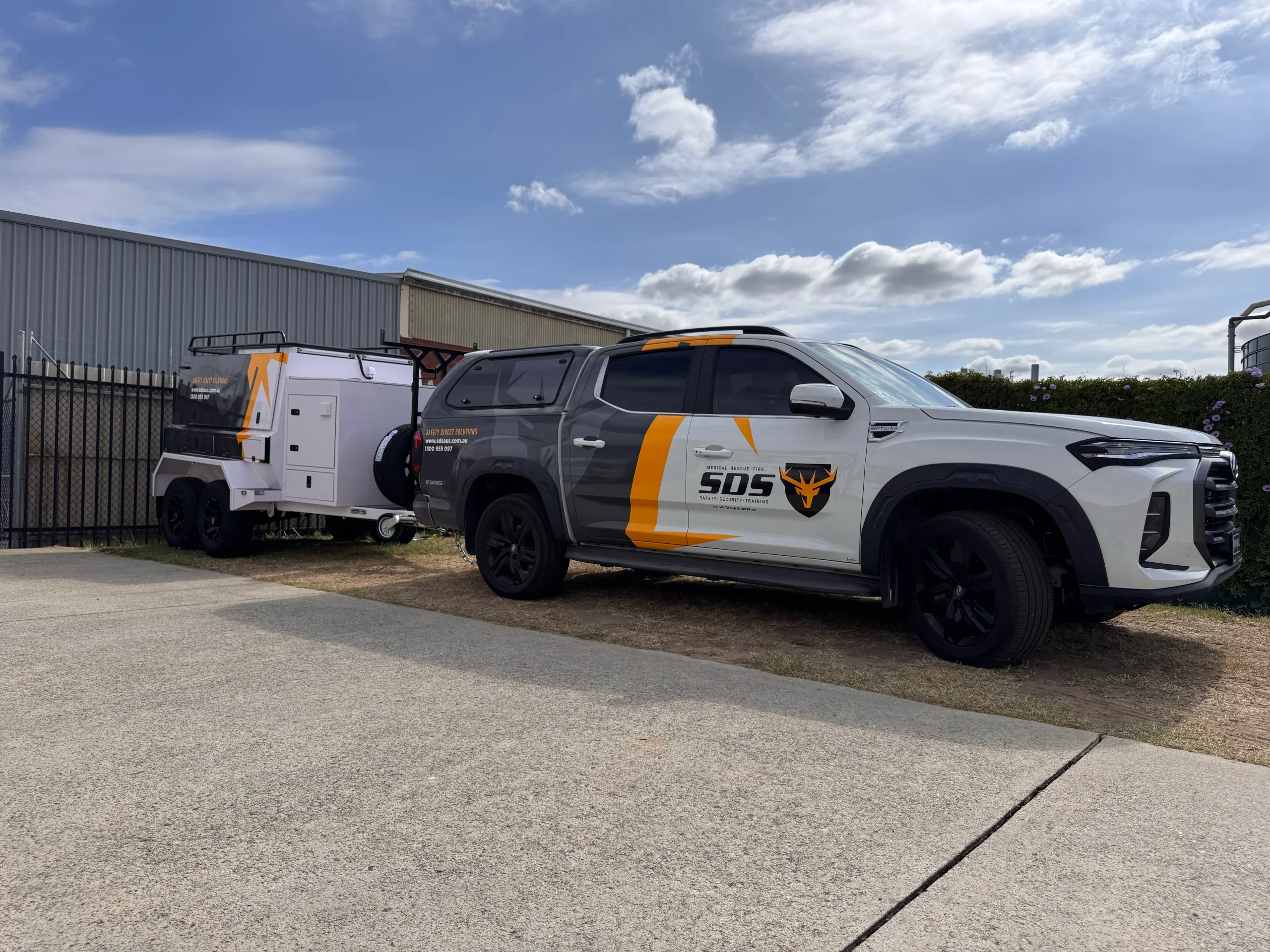 Safety Direct Solutions LDV ute and matching trailer with grey, white and yellow graphics