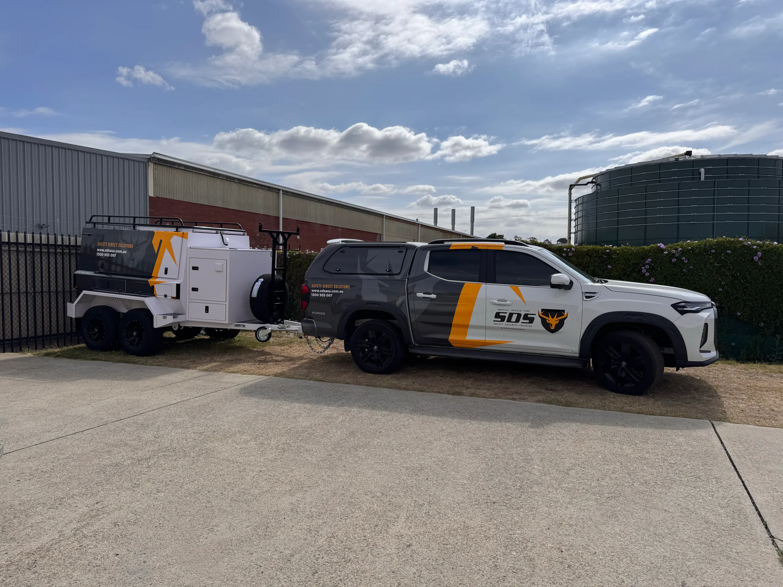 Side view of the SDS ute and matching equipment trailer outside the workshop