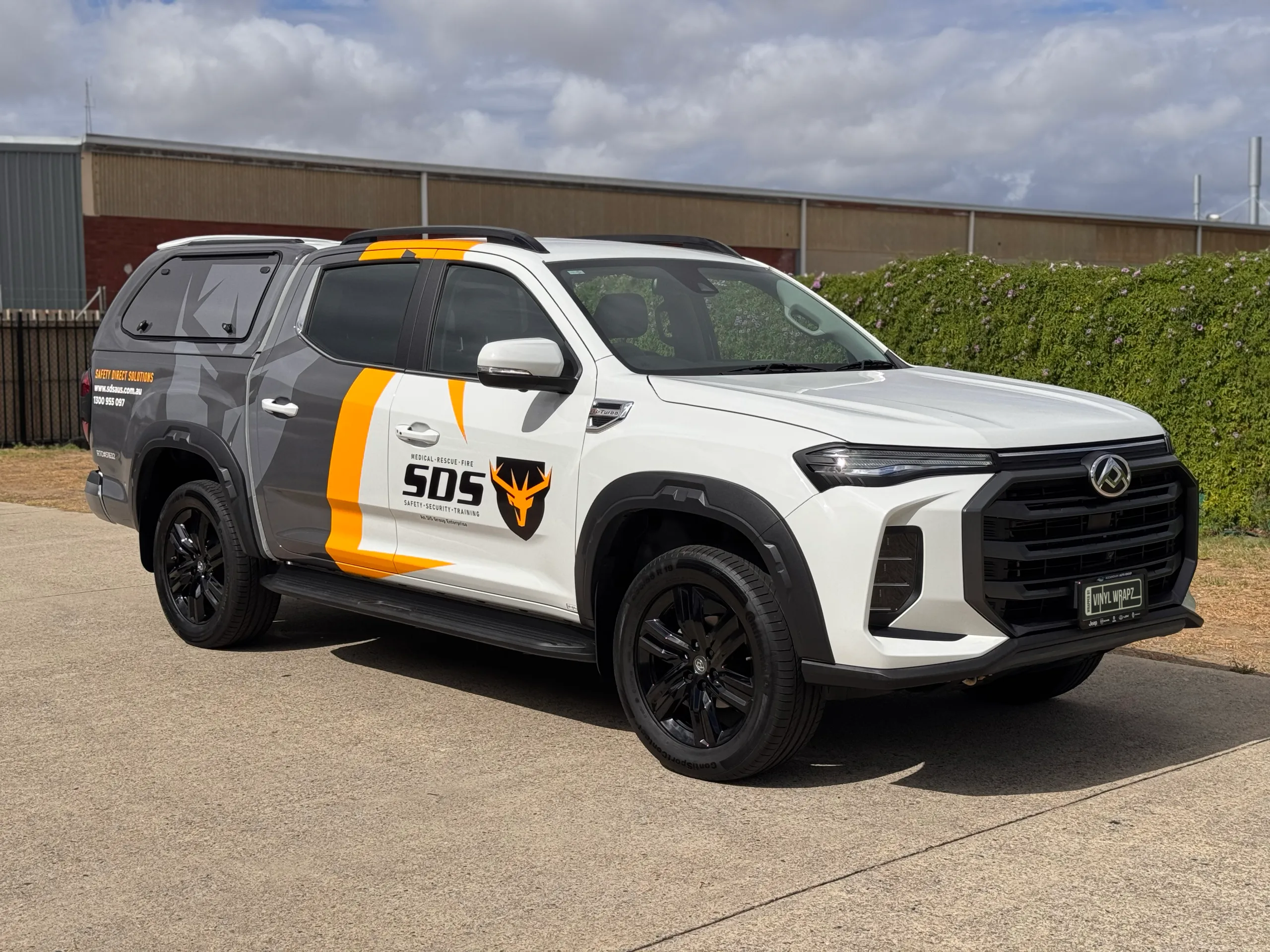 White and grey LDV ute with yellow SDS branding outside the workshop