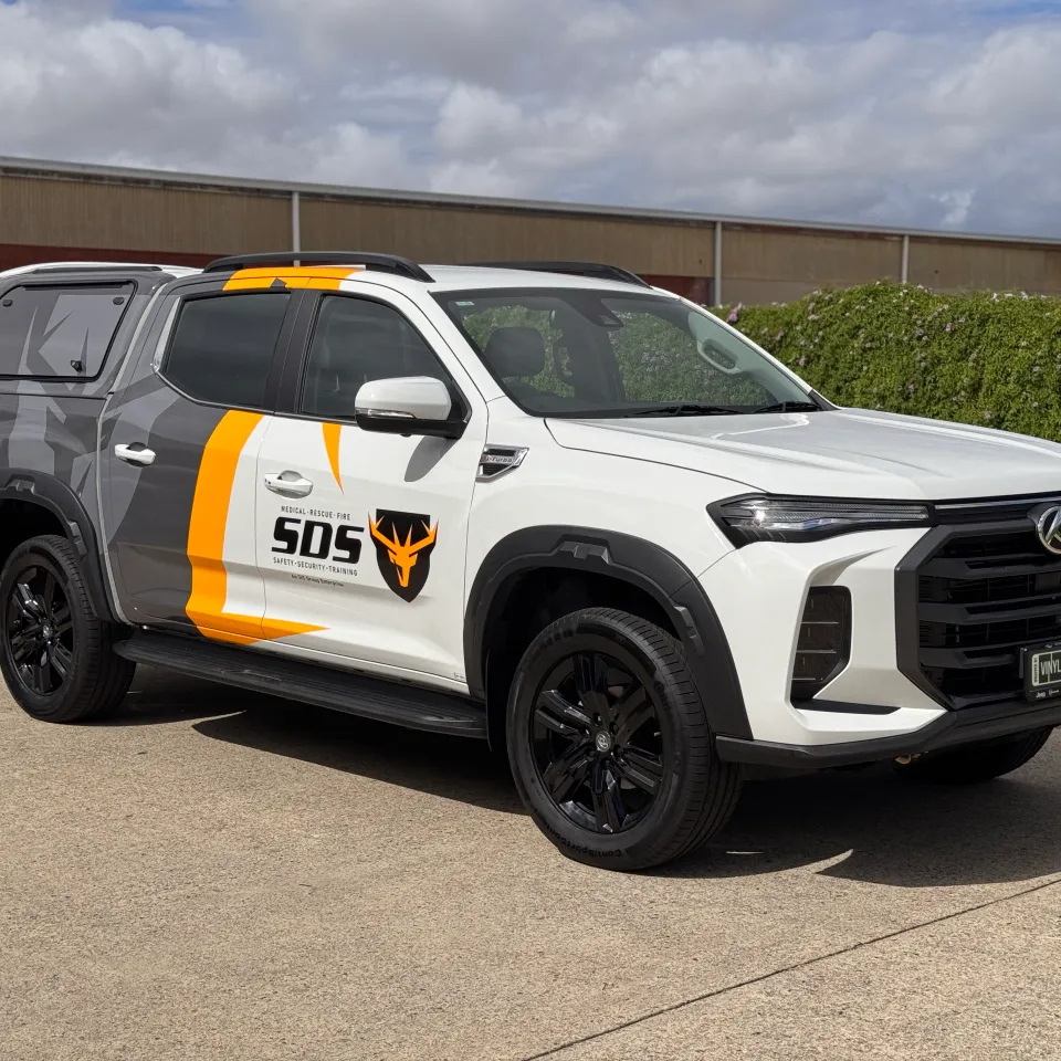 White and grey LDV ute with yellow SDS branding outside the workshop