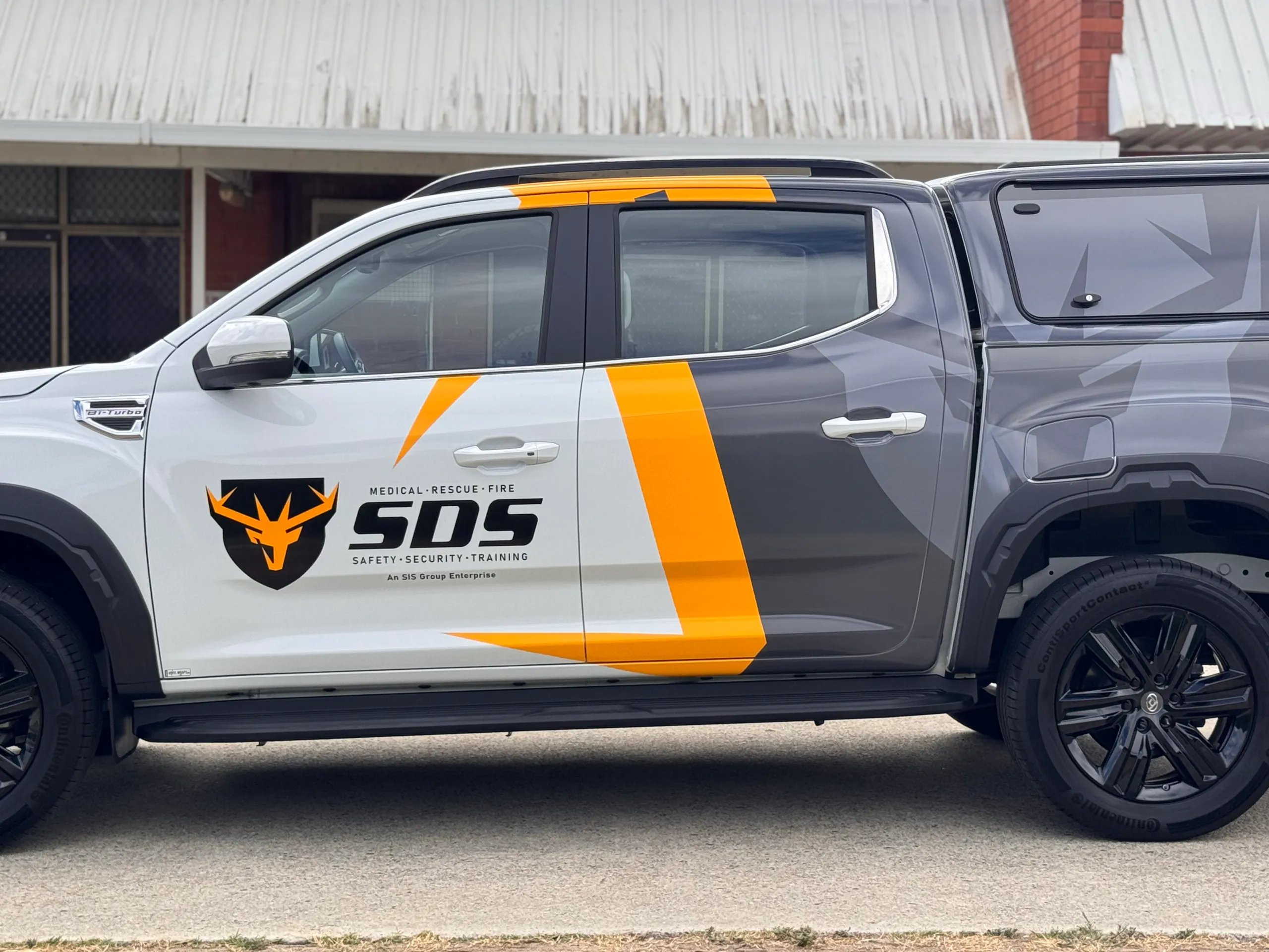 White LDV ute doors with black SDS lettering and yellow graphics
