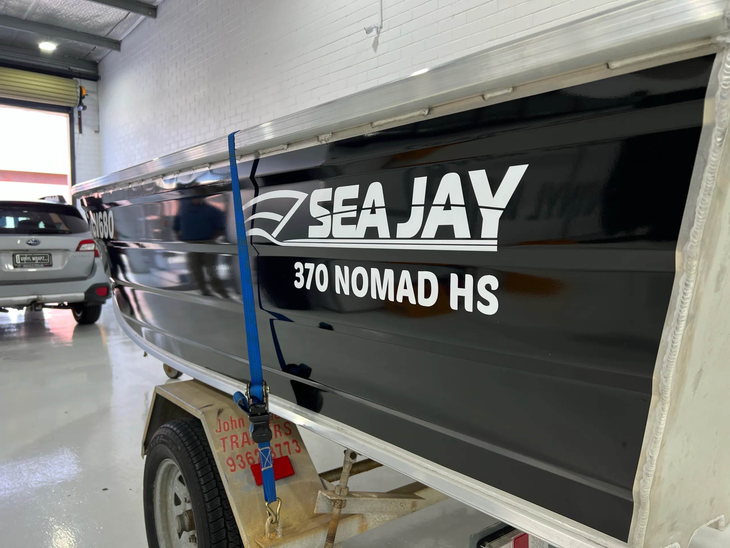 Sea Jay 370 Nomad HS lettering on the gloss black dinghy side near the stern