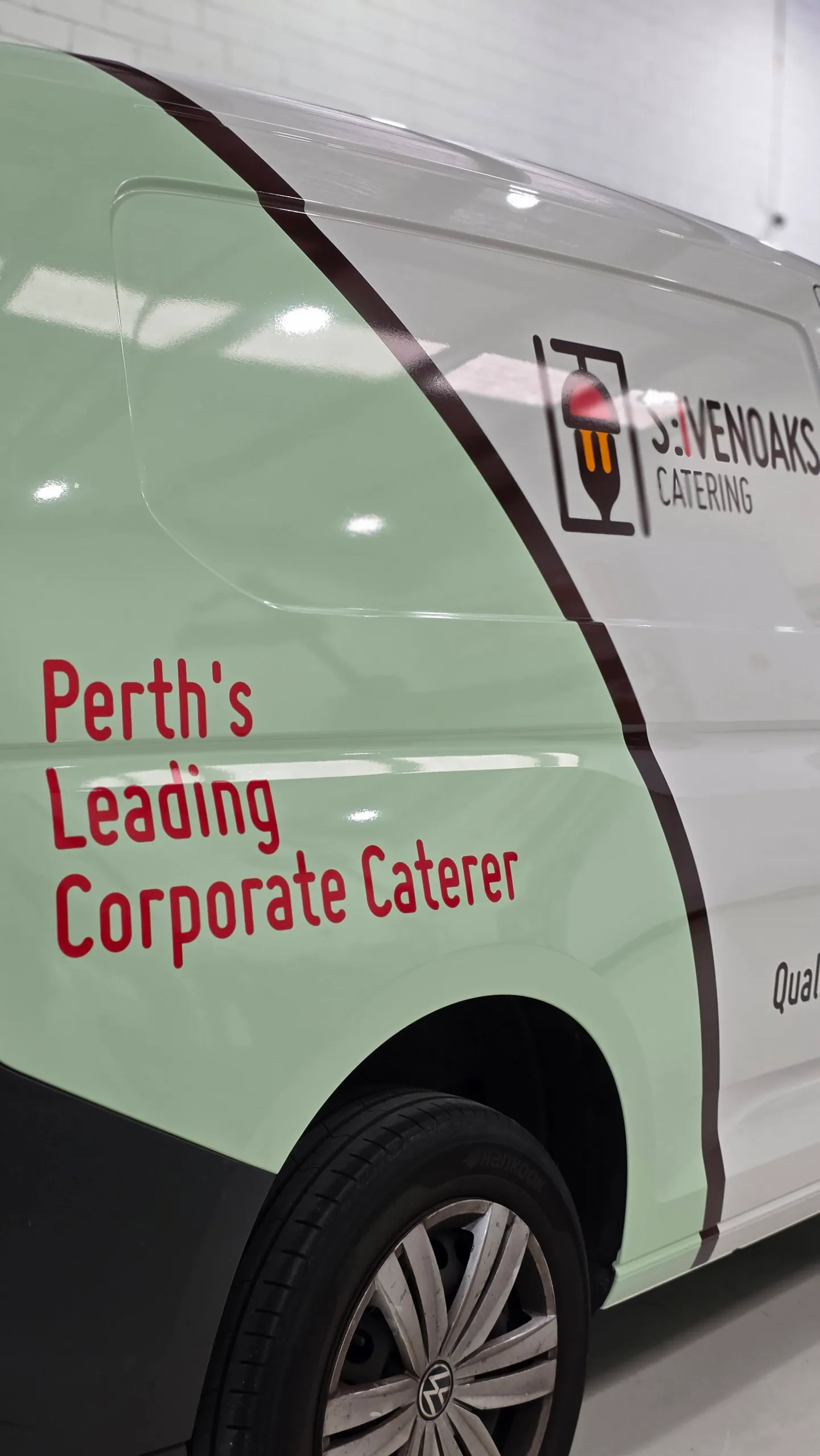 Sevenoaks Catering graphics on the mint green and white rear side panel of a Volkswagen Caddy