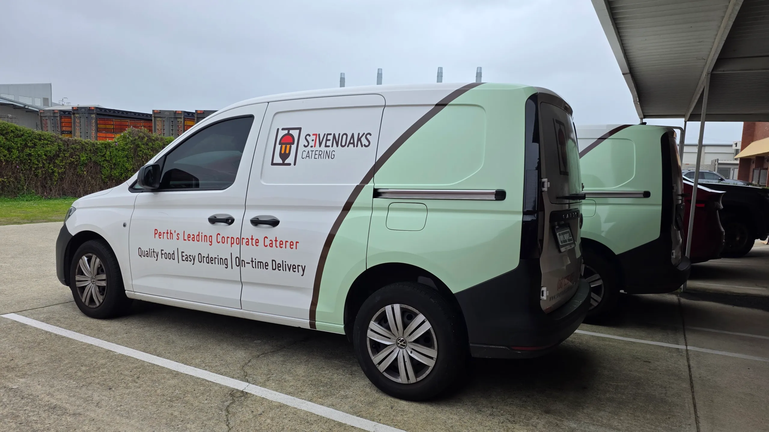 Sevenoaks Catering Volkswagen Caddy parked beside another branded van outdoors