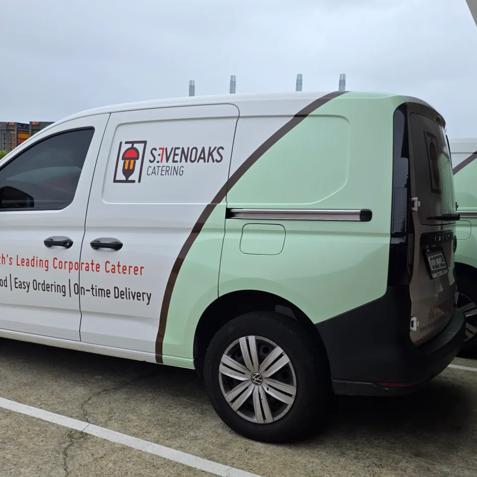 Sevenoaks Catering Volkswagen Caddy parked beside another branded van outdoors