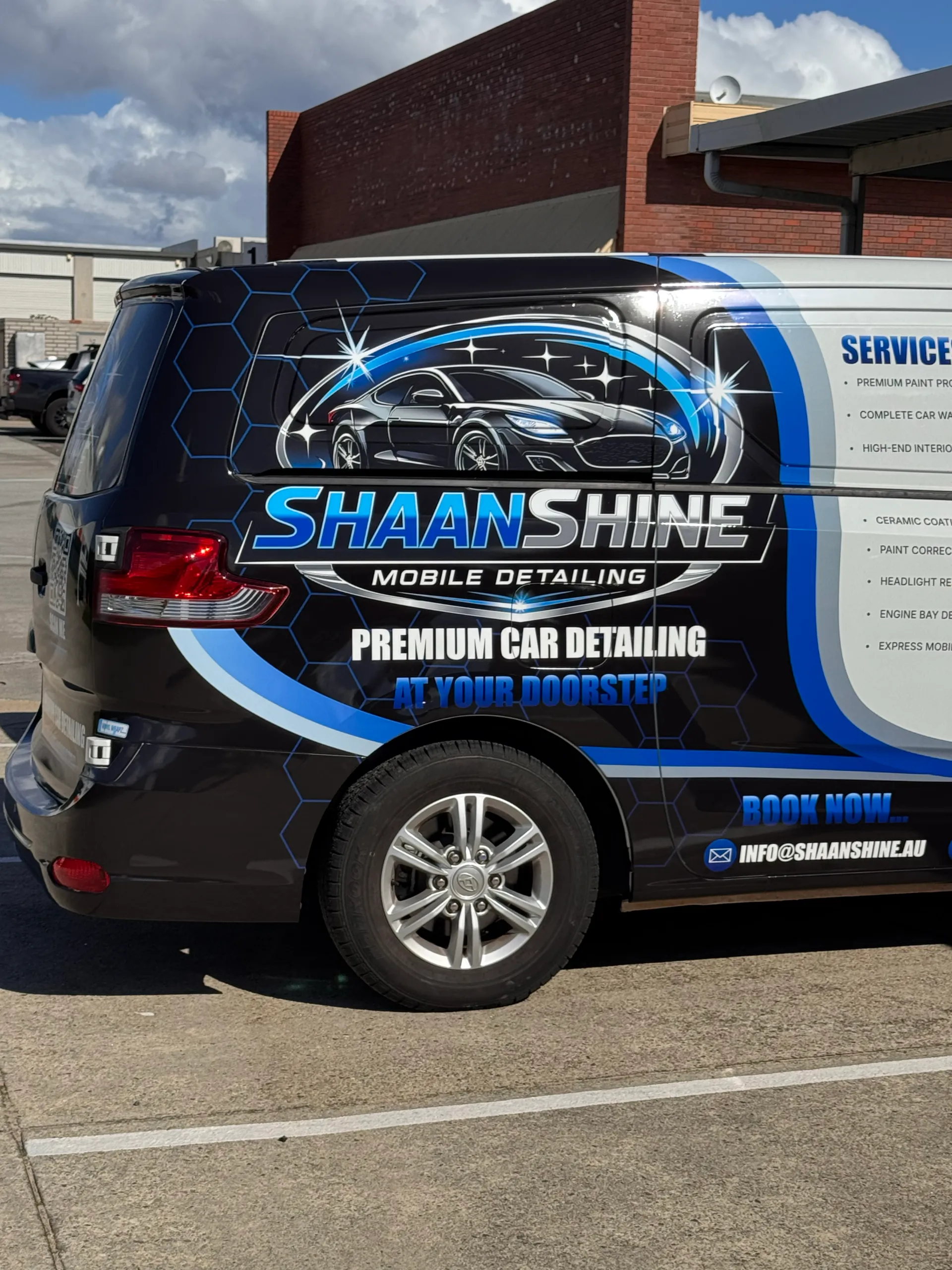 Shaan Shine Mobile Detailing logo and car graphic on the side of a van