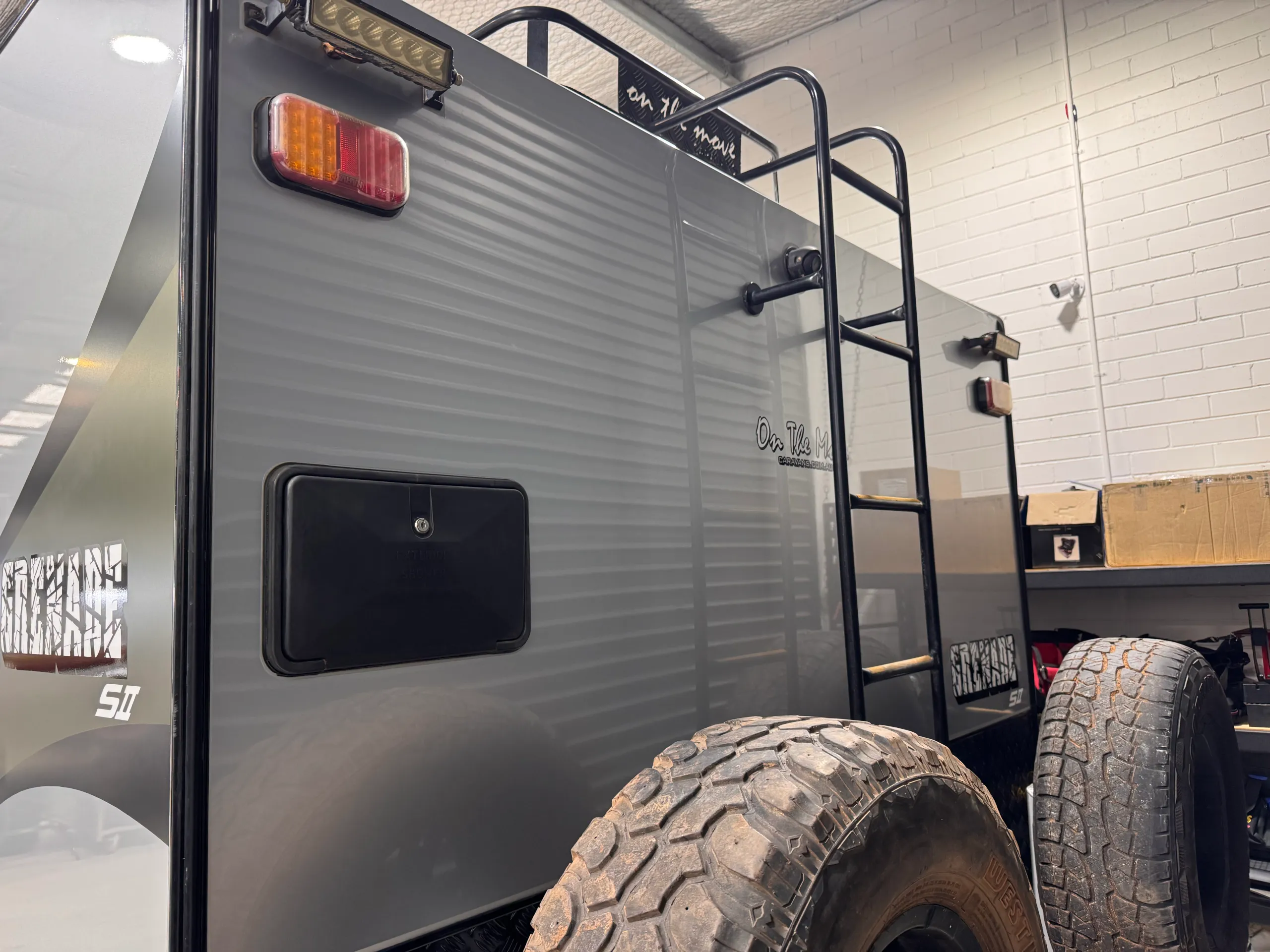Silver caravan rear panel, ladder and spare wheels after its exterior refresh