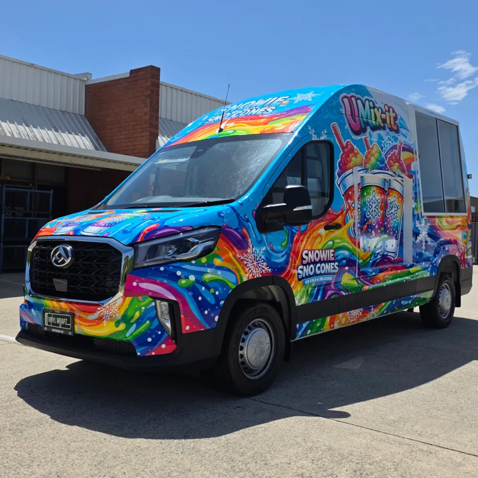Snowie Sno Cones LDV van viewed from the front quarter, with rainbow graphics across its cab and side
