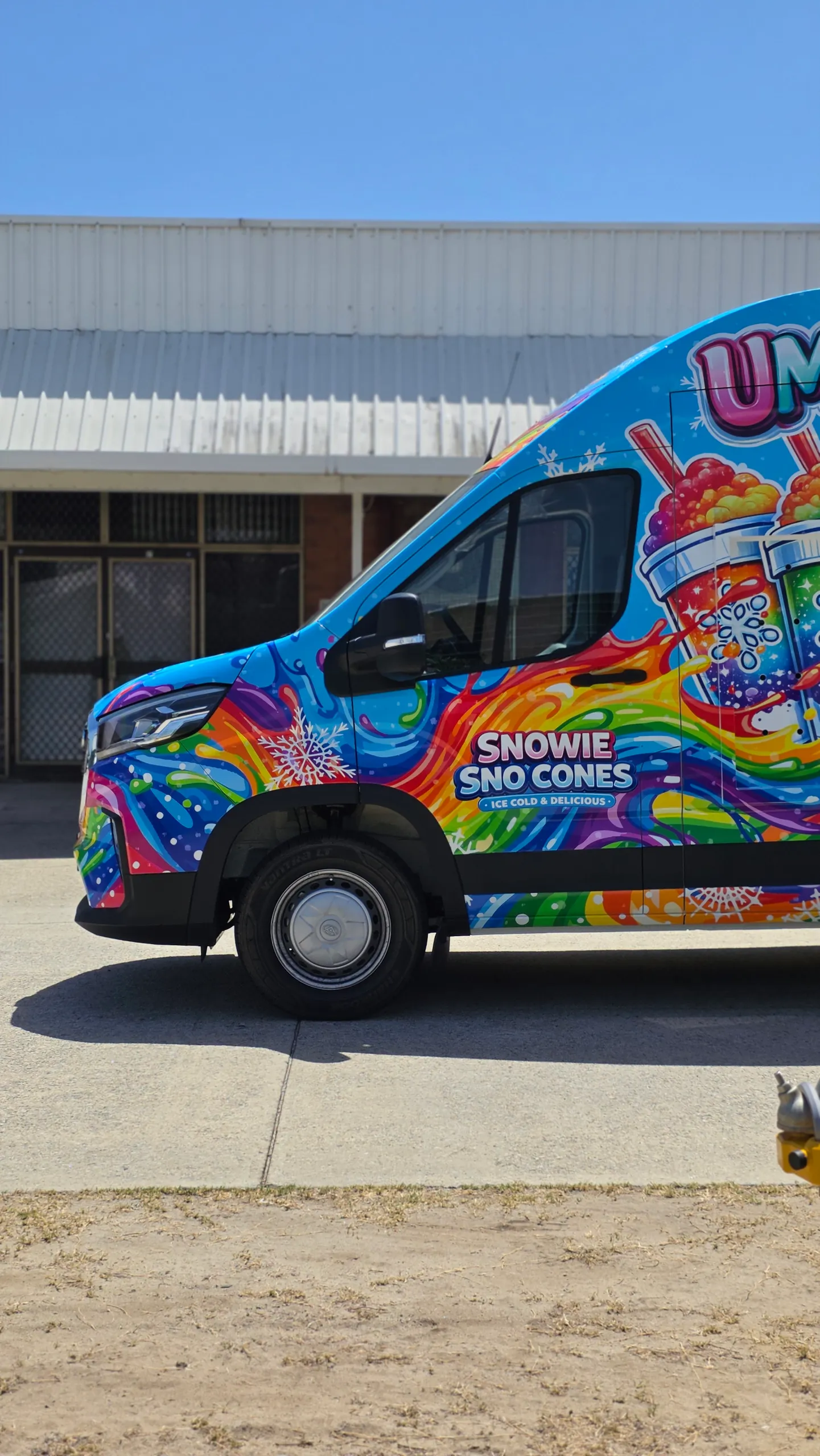 Side of the Snowie Sno Cones van cab showing its logo and colourful drink graphics