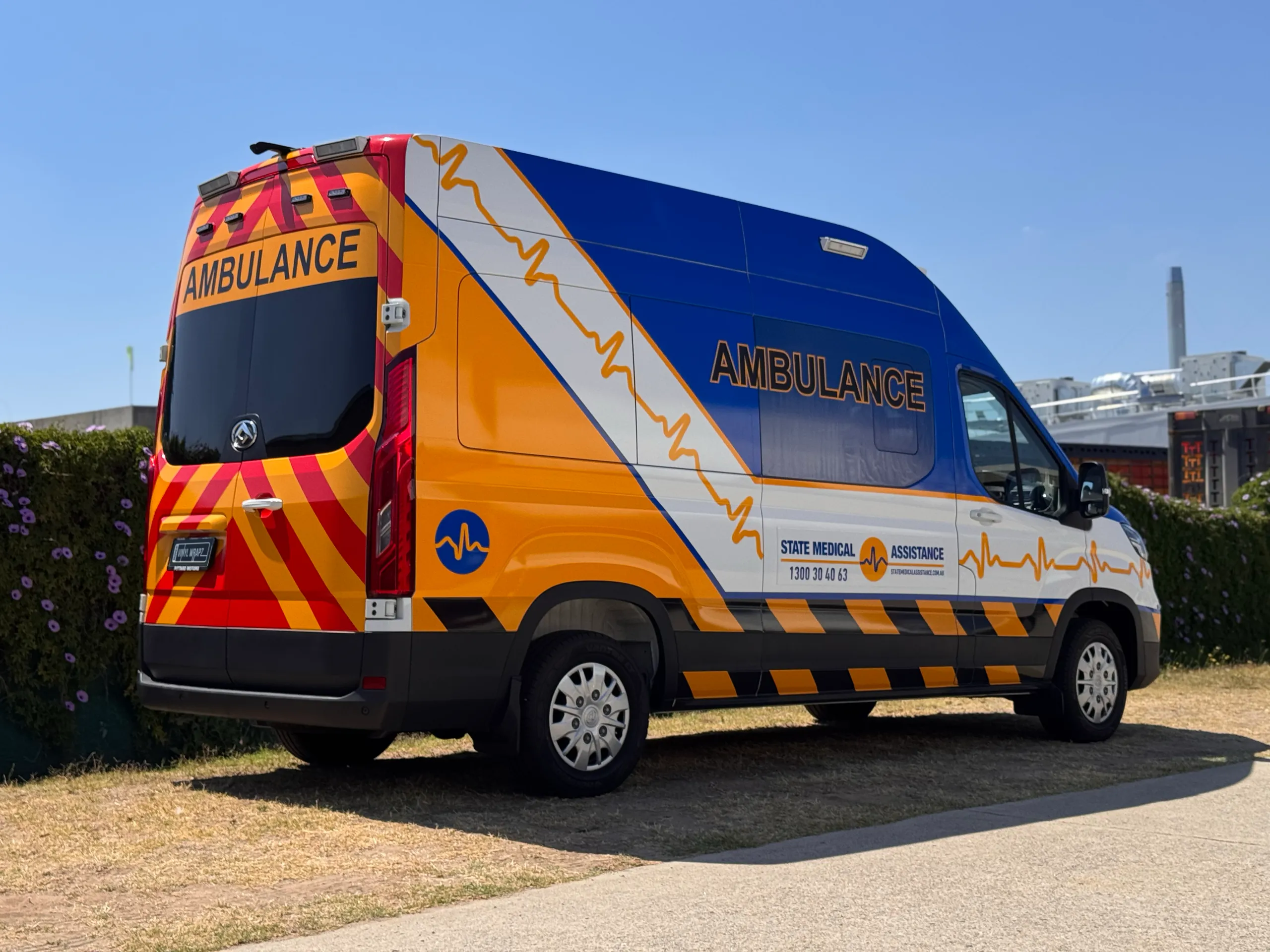 State Medical Assistance LDV ambulance with blue and yellow graphics and red rear chevrons