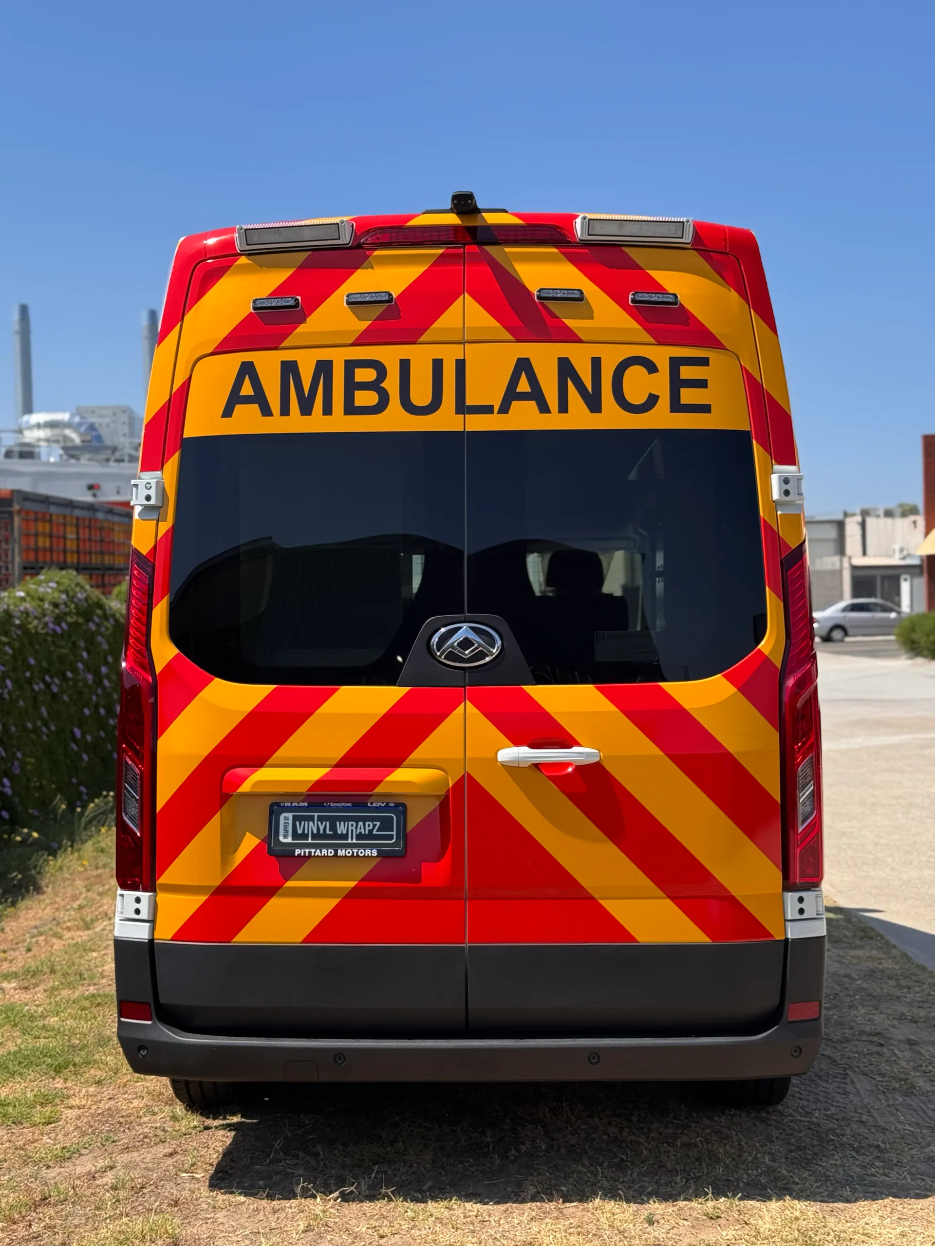 Rear view of the LDV ambulance with red and yellow chevrons and black ambulance lettering