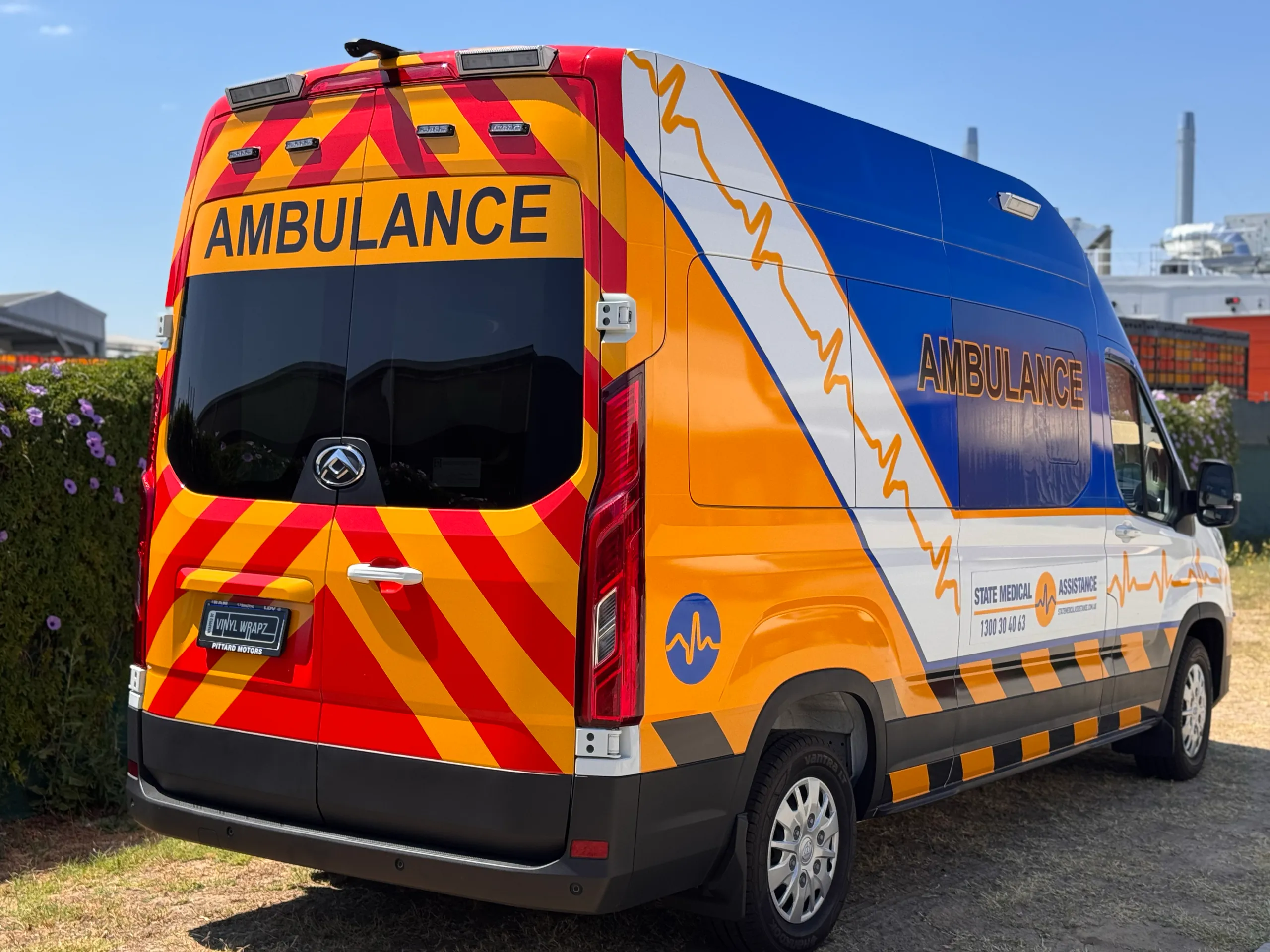 Blue and yellow State Medical Assistance graphics along the LDV ambulance side and rear