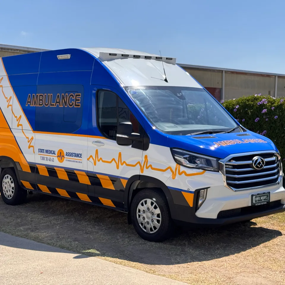 State Medical Assistance LDV ambulance with blue and yellow graphics outside the workshop