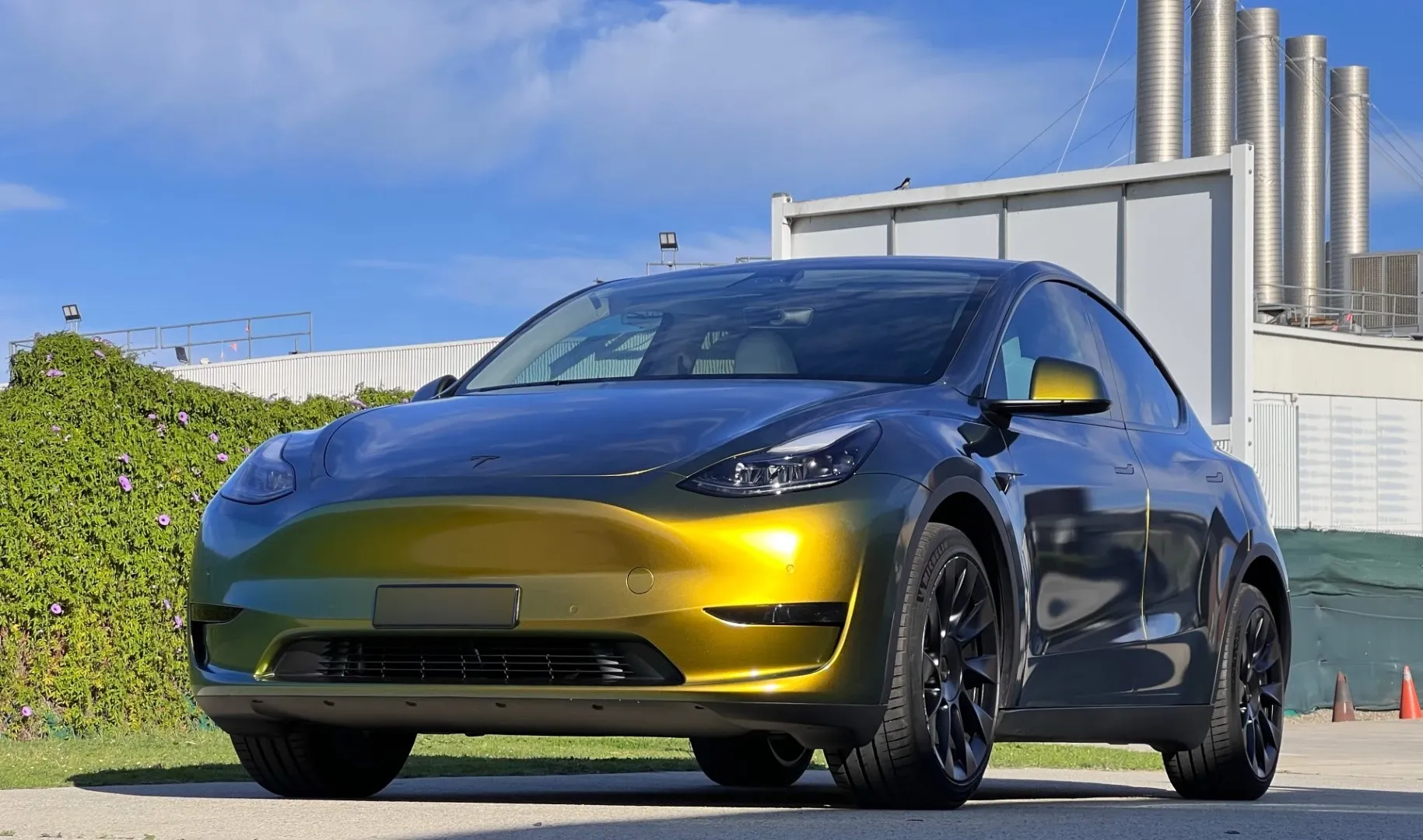 Tesla Model Y in a gold to green colour shift wrap at the Vinyl Wrapz workshop