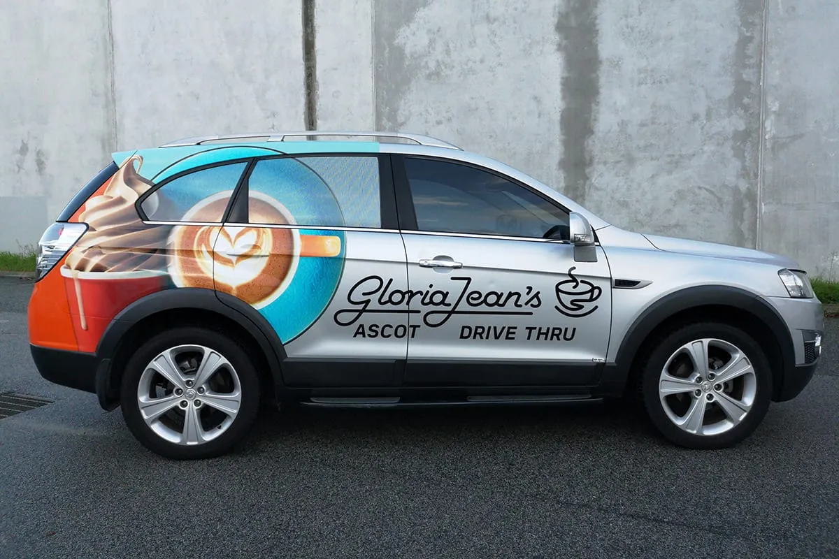 Holden Captiva SUV with a printed coffee-cup partial wrap on the rear quarter and cafe lettering on the doors, wrapped by Vinyl Wrapz