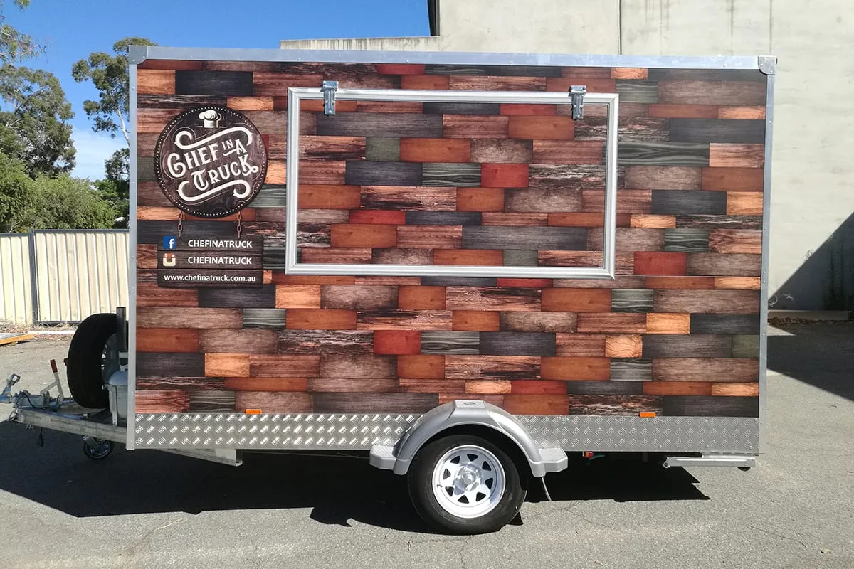 Perth food trailer in a full printed timber-plank wrap with the serving hatch framed inside the design, by Vinyl Wrapz