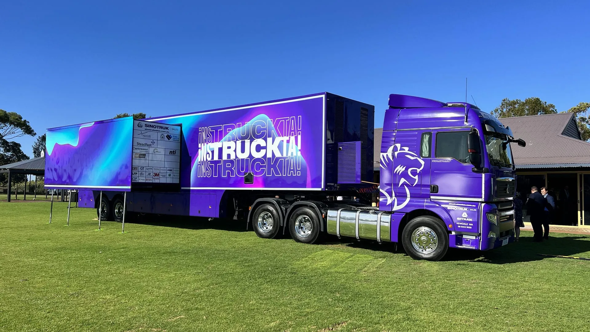 Instrukta prime mover and trailer in a full purple commercial wrap