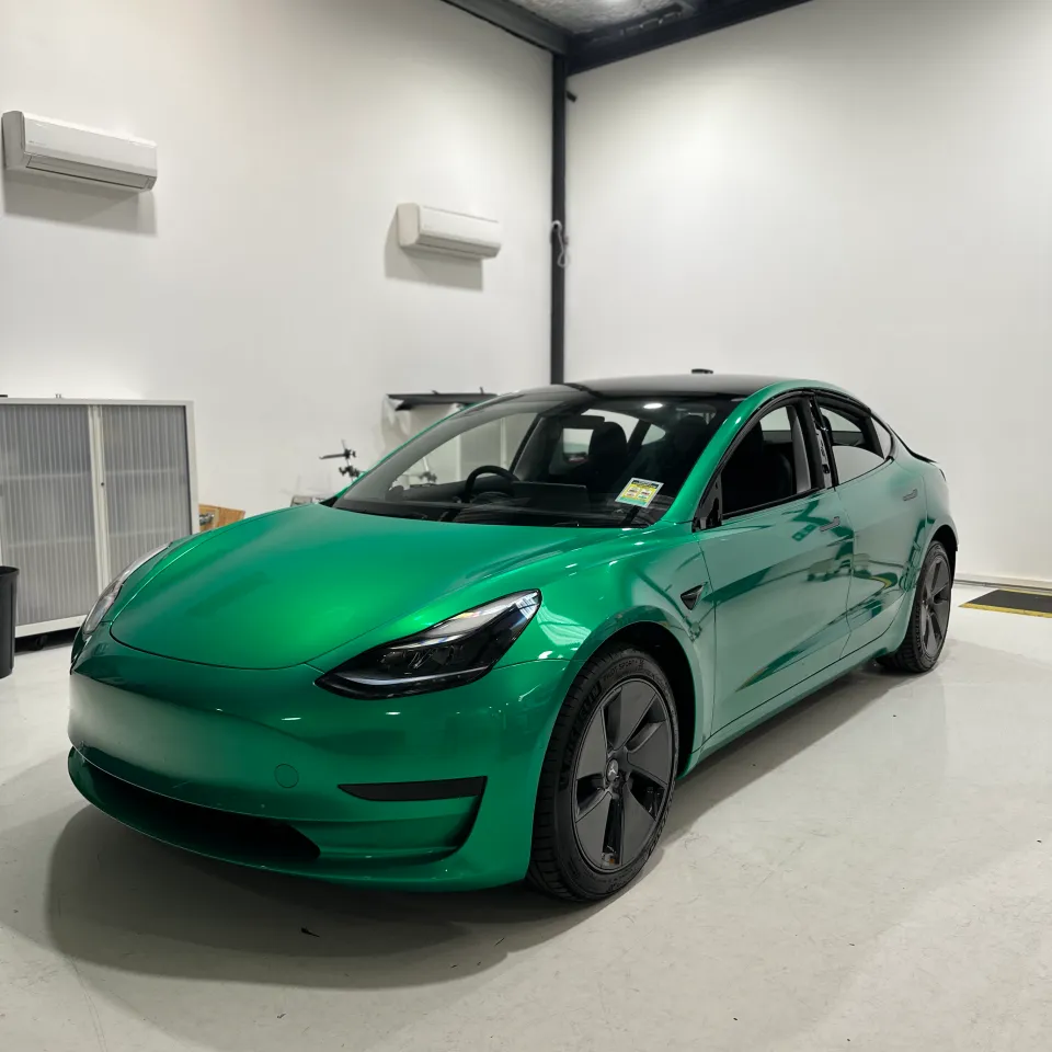 Envious green Tesla Model 3, front quarter